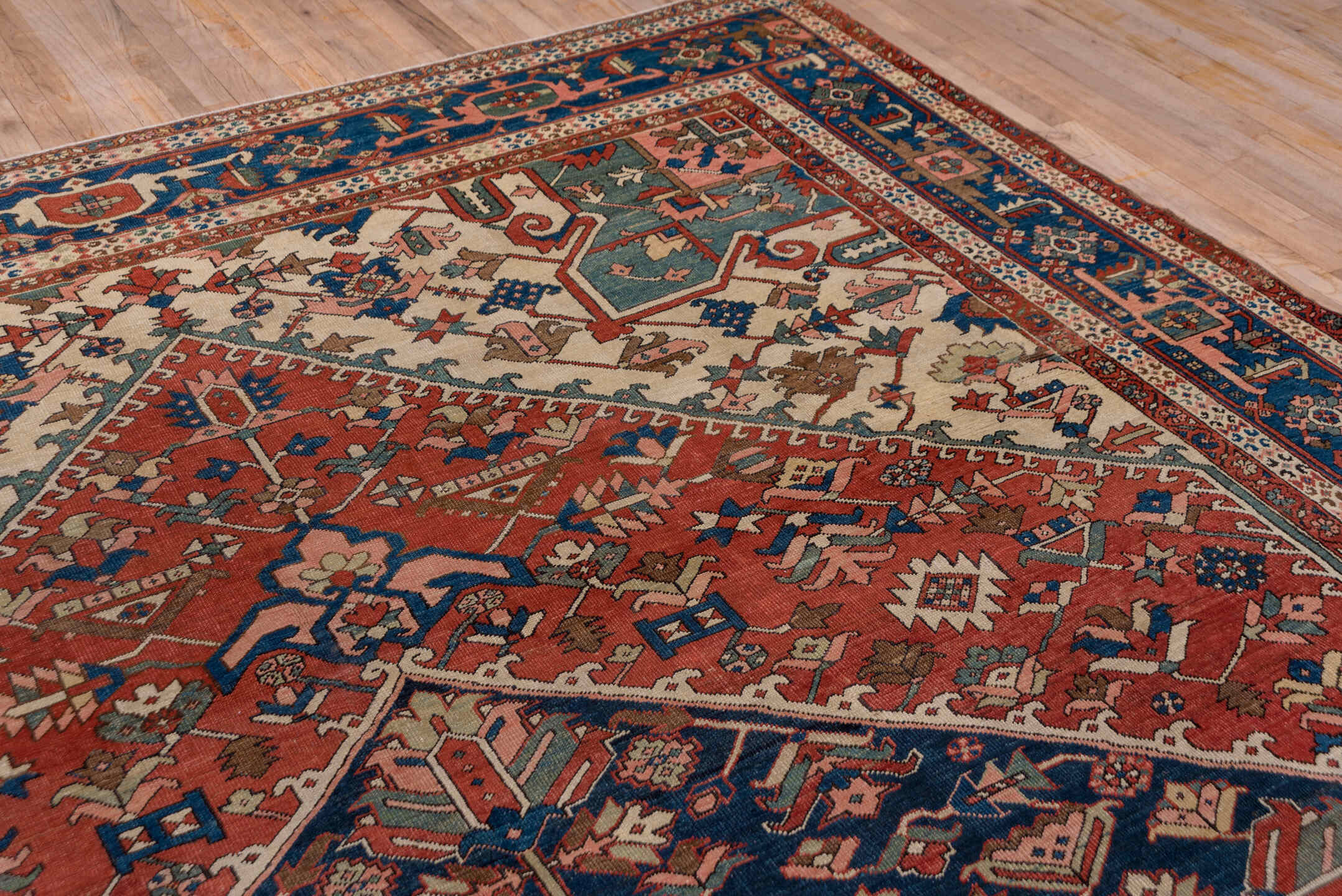 10' x 14' one-of-a-kind handmade antique Serapi large size rug. Color palette: rust, ivory, indigo, sky blue, rose, taupe