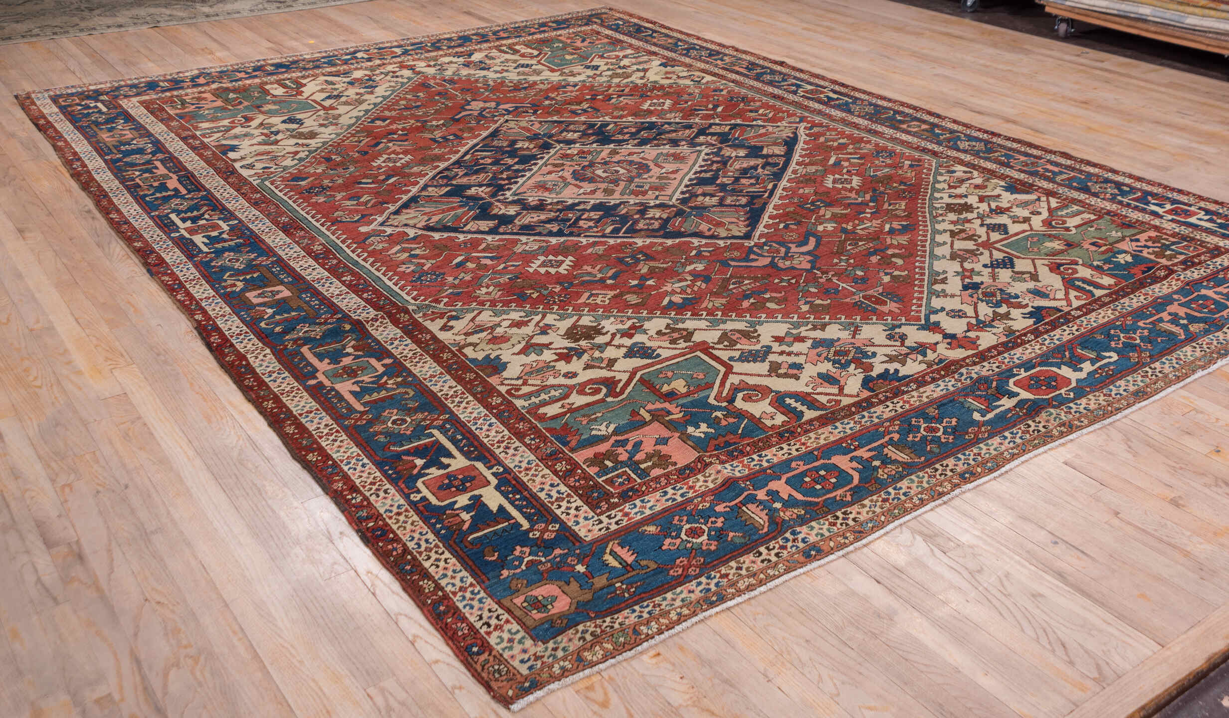 10' x 14' one-of-a-kind handmade antique Serapi large size rug. Color palette: rust, ivory, indigo, sky blue, rose, taupe