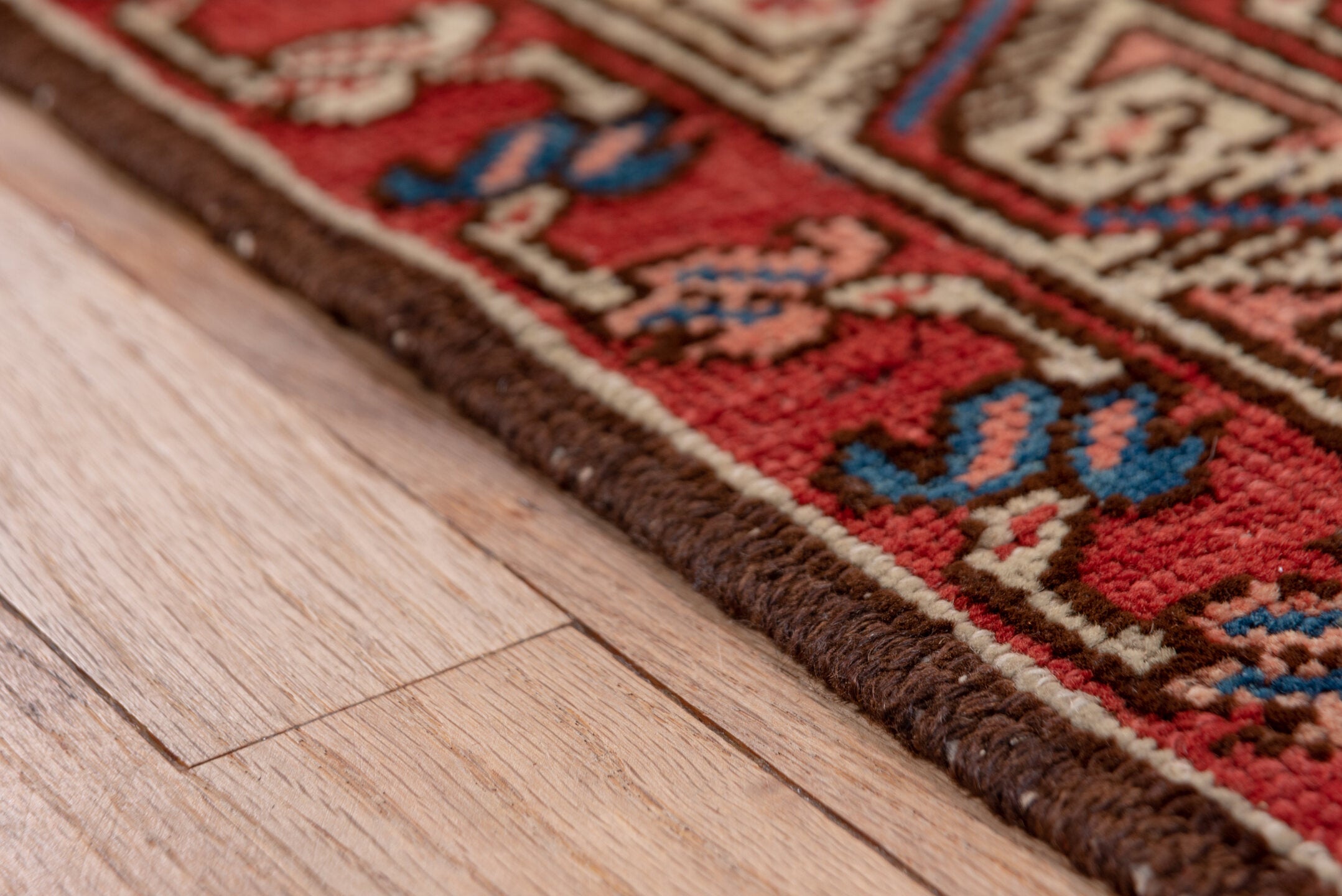 3' x 11' one-of-a-kind handmade vintage Serapi runner rug. Color palette: blue, brown, gray, pink, red