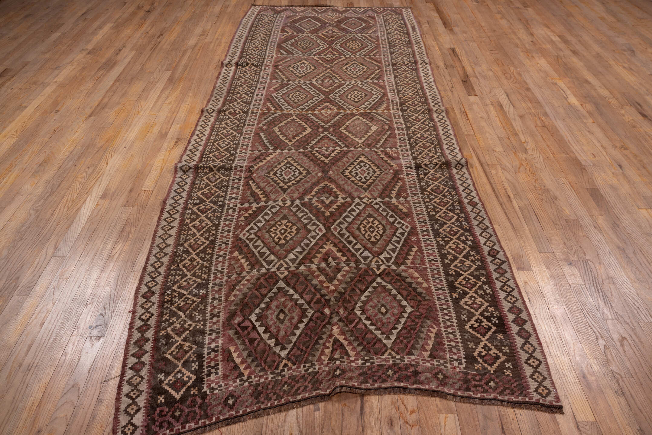 4' x 11' one-of-a-kind handmade vintage Kilim runner rug. Color palette: rose, rust, brown, ivory, taupe, mauve, pink, red