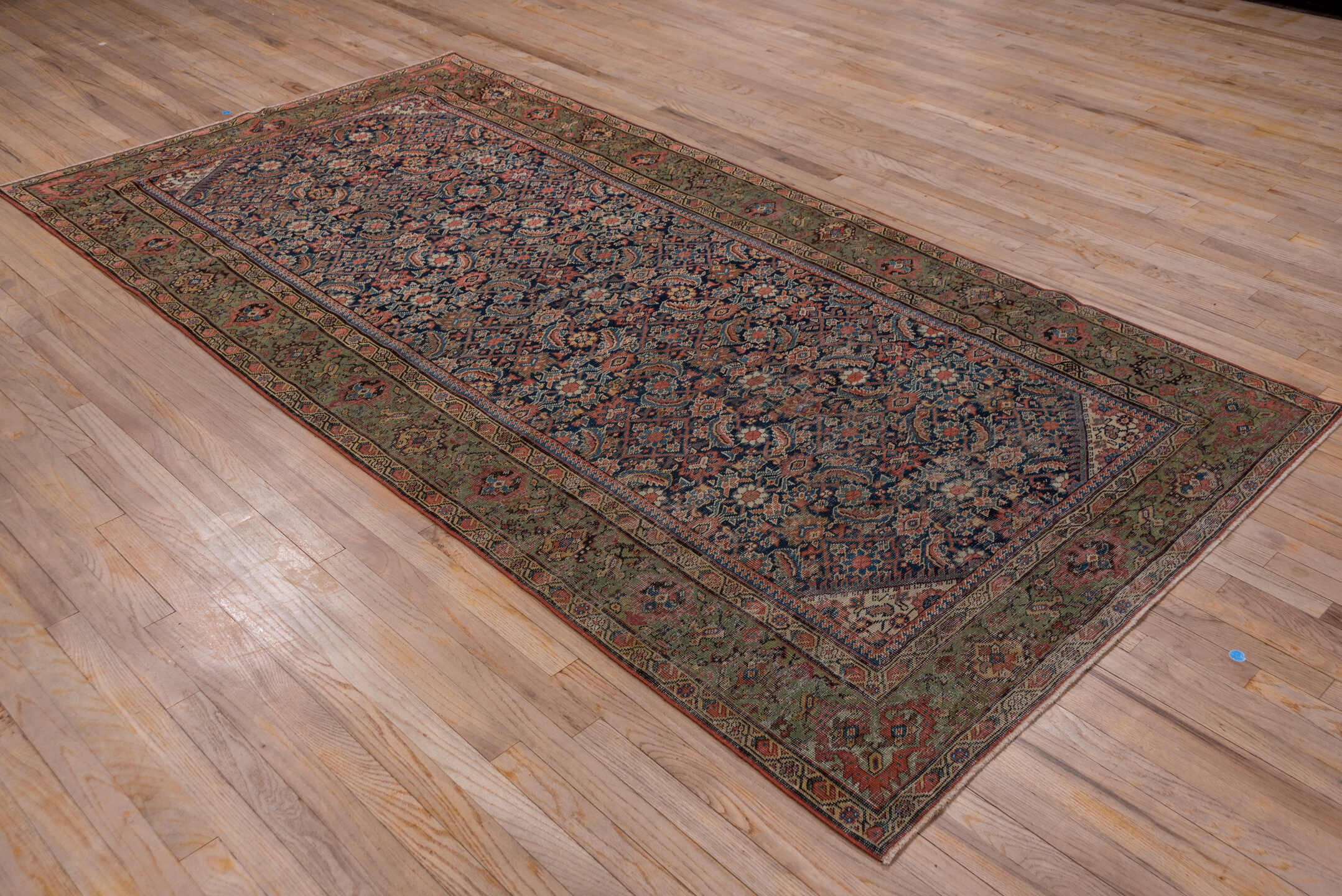 5' x 9' one-of-a-kind handmade vintage Farahan medium size rug. Color palette: black, blue, brown, gray, pink, red, redwood