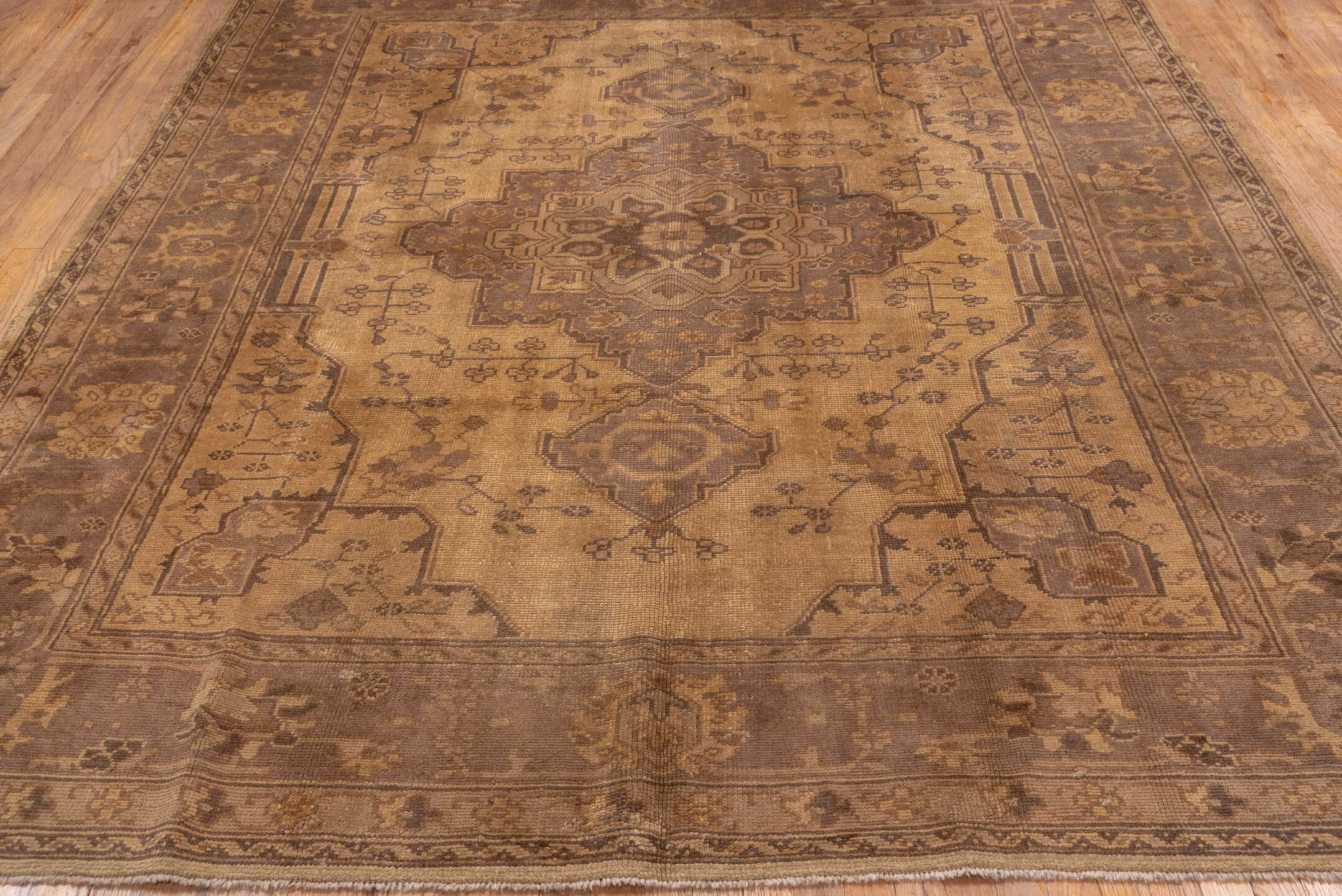 7' x 9' one-of-a-kind handmade antique Oushak rug. Color palette: beige, taupe, camel, brown, ivory, sand, mauve, gray, pink