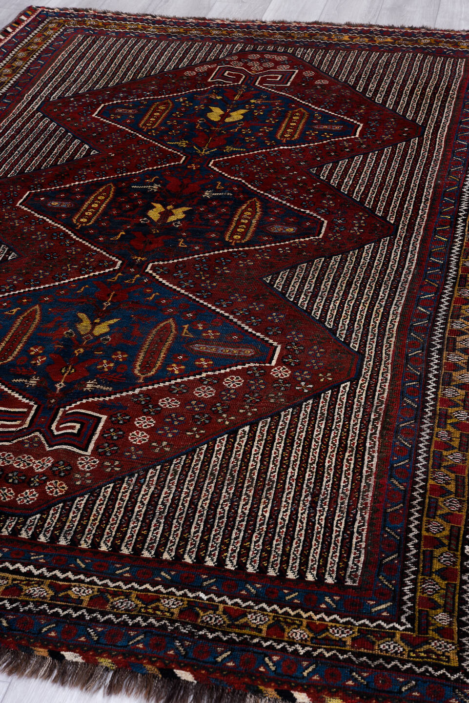 5' x 8' one-of-a-kind handmade vintage Qashqai medium size rug. Color palette: blue, brown, gray, light gray, off-white
