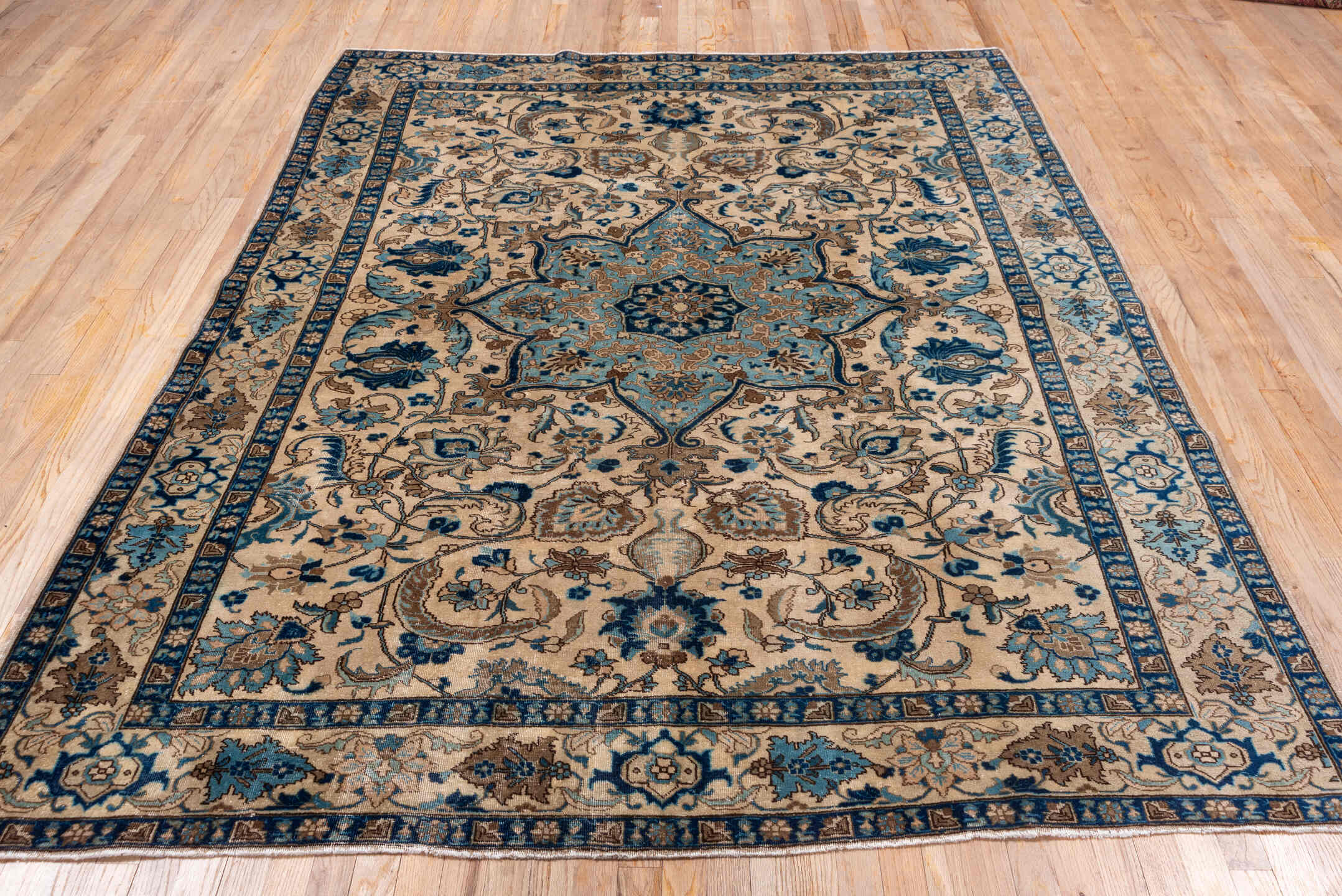 6' x 8' one-of-a-kind handmade antique Tabriz medium size rug. Color palette: ivory, sky blue, navy, taupe, camel, brown