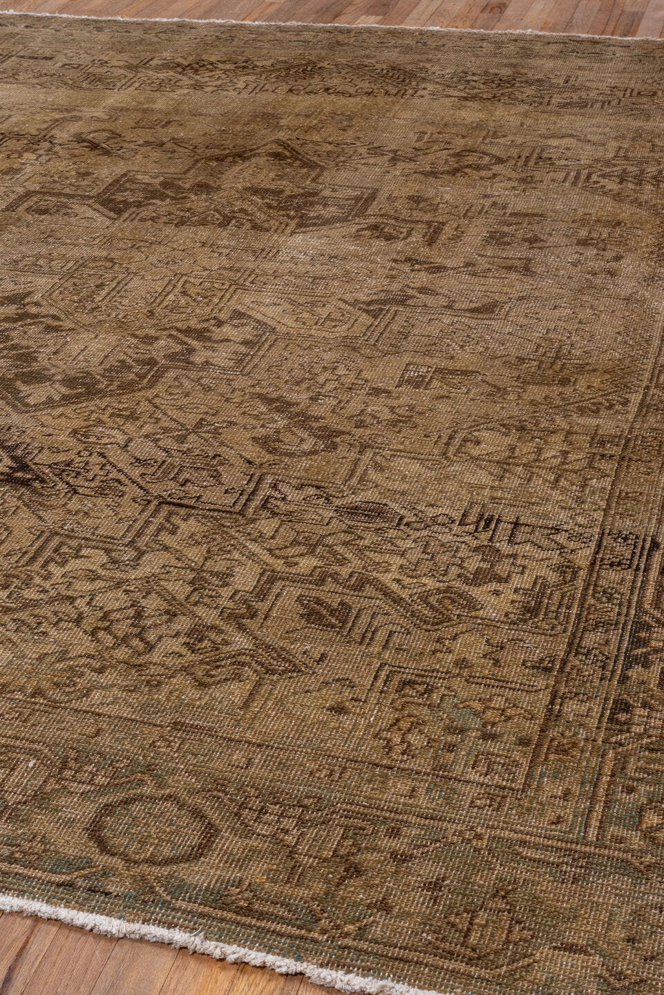 7' x 9' one-of-a-kind handmade antique Heriz rug. Color palette: taupe, camel, brown, ivory, charcoal, sage, slate, beige