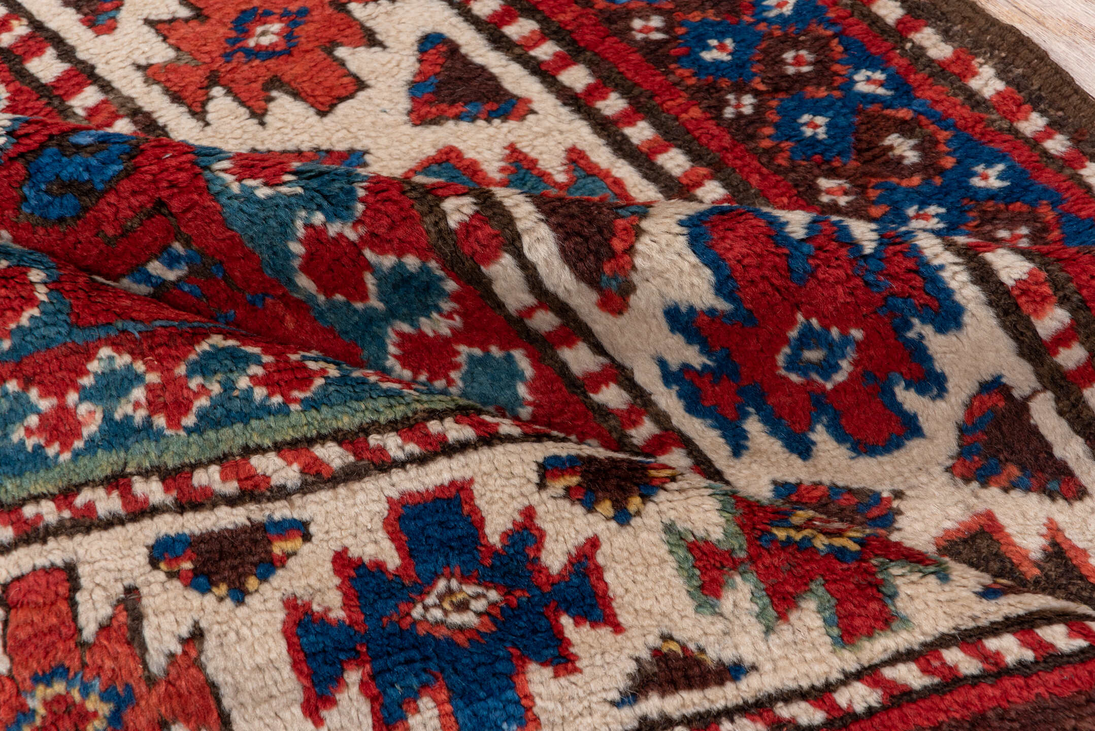 3' x 8' one-of-a-kind handmade vintage Kazak runner rug. Color palette: red, ivory, blue, rust, navy, turquoise, brown