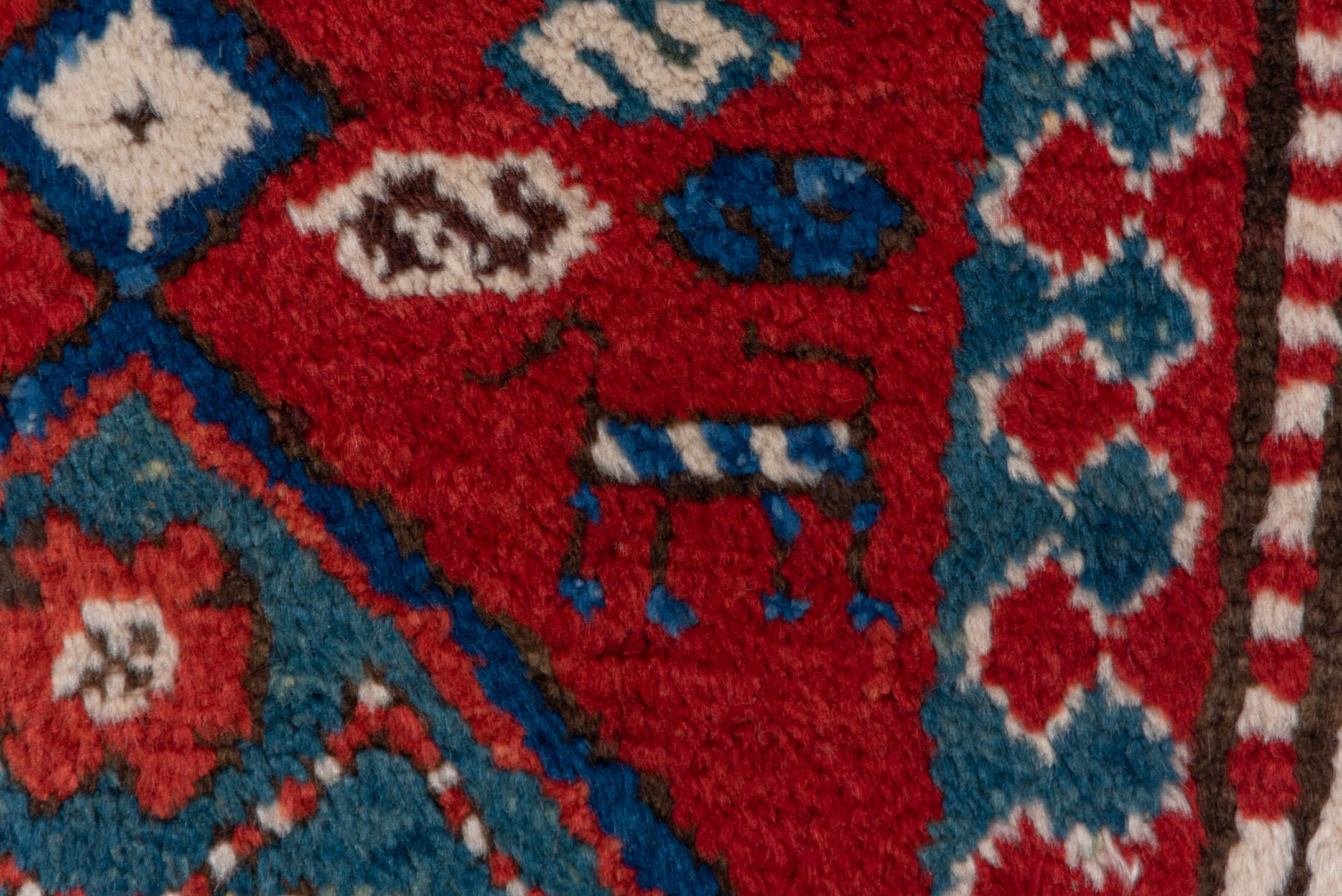 3' x 8' one-of-a-kind handmade vintage Kazak runner rug. Color palette: red, ivory, blue, rust, navy, turquoise, brown