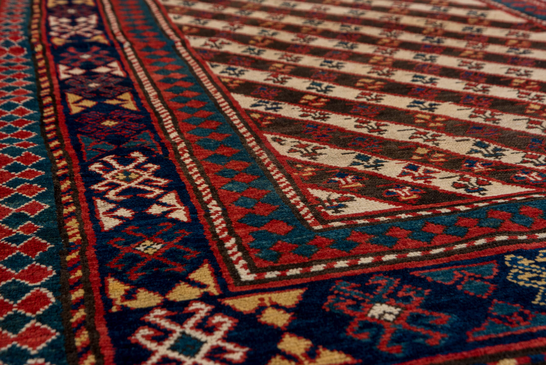 3' x 7' one-of-a-kind handmade vintage Kazak rug. Color palette: ivory, navy, teal, rust, crimson, gold, blue, terracotta
