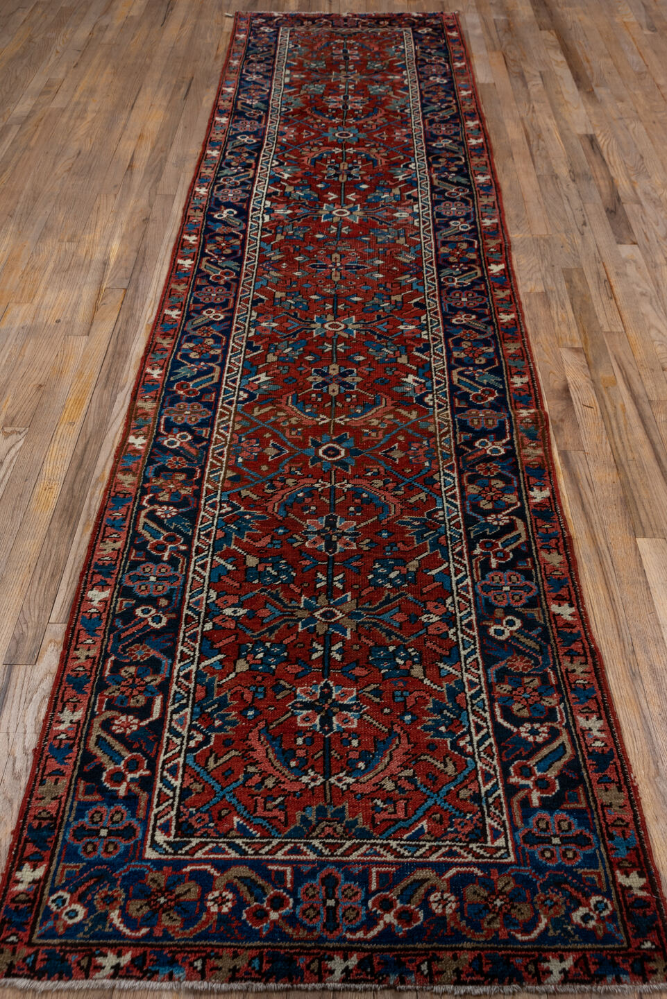3' x 12' one-of-a-kind handmade vintage Heriz runner rug. Color palette: blue, brown, gray, orange, pink, red, wine