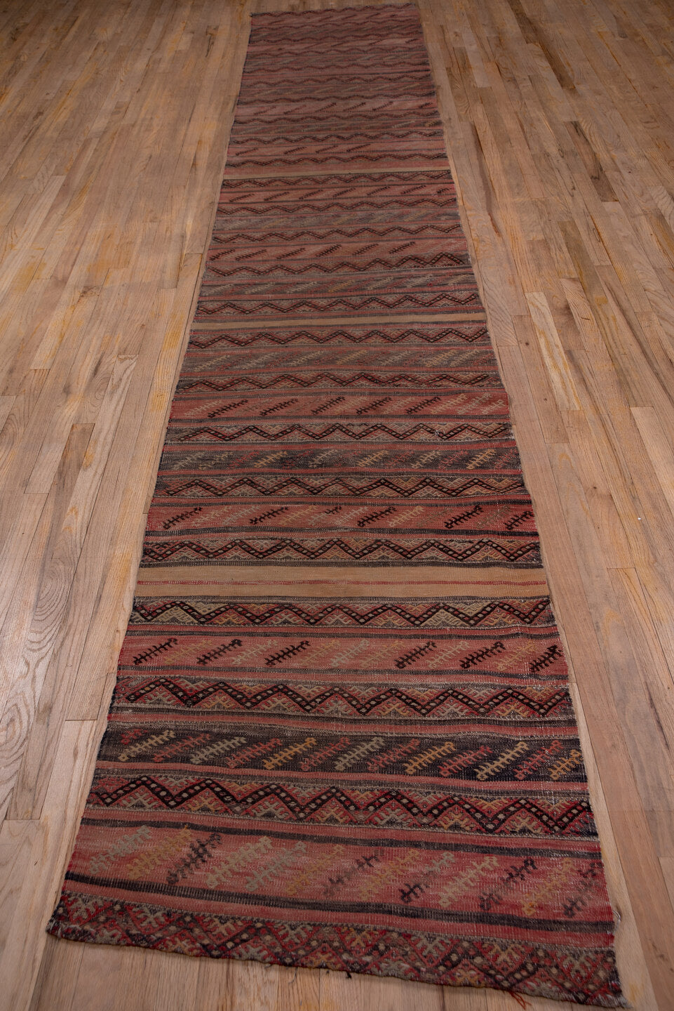 2' x 15' one-of-a-kind handmade vintage Jijim runner rug. Color palette: brown, gray, off-white, pink, red, redwood, snow