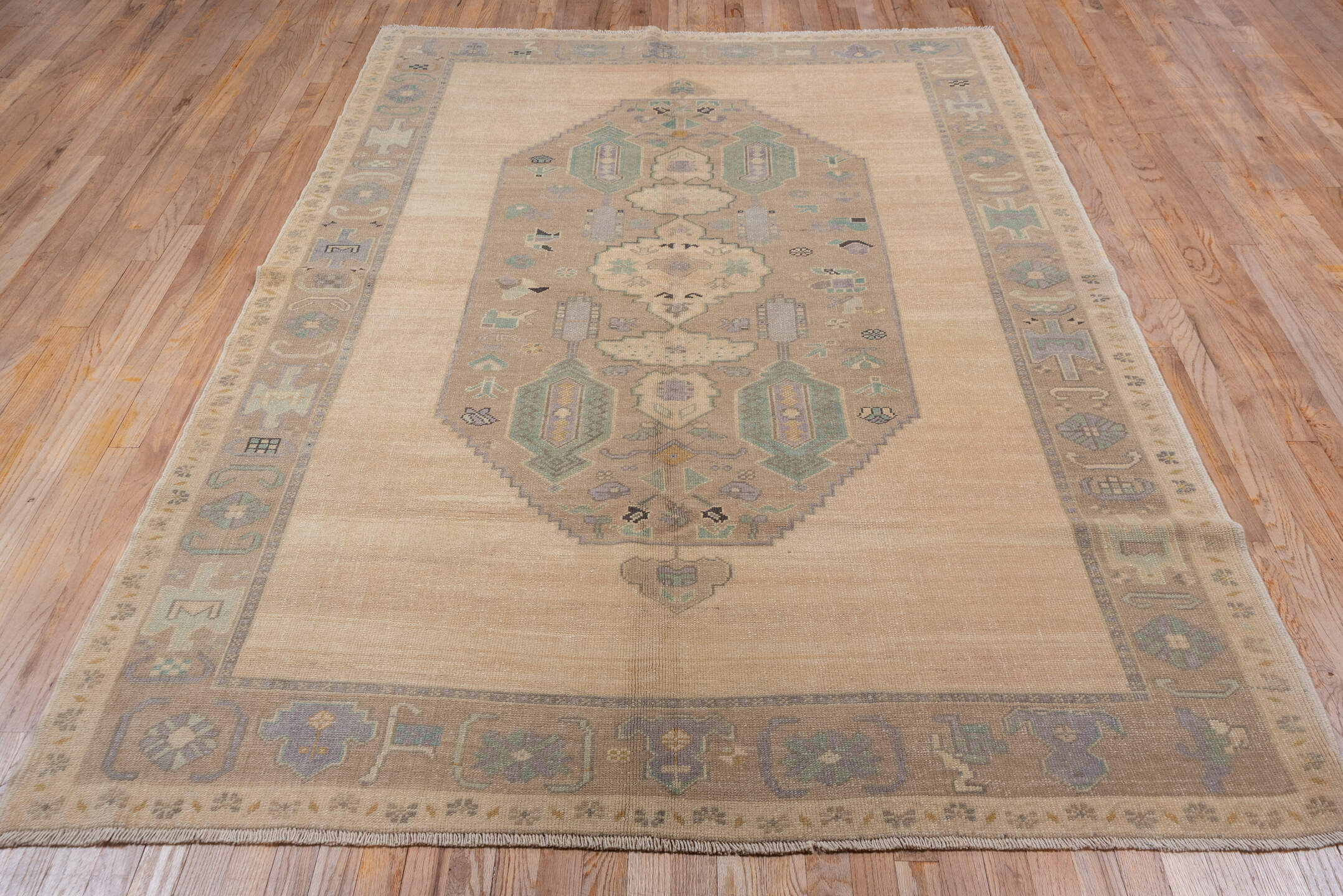 6' x 8' one-of-a-kind handmade vintage Oushak medium size rug. Color palette: ivory, taupe, beige, sage, pale blue, camel
