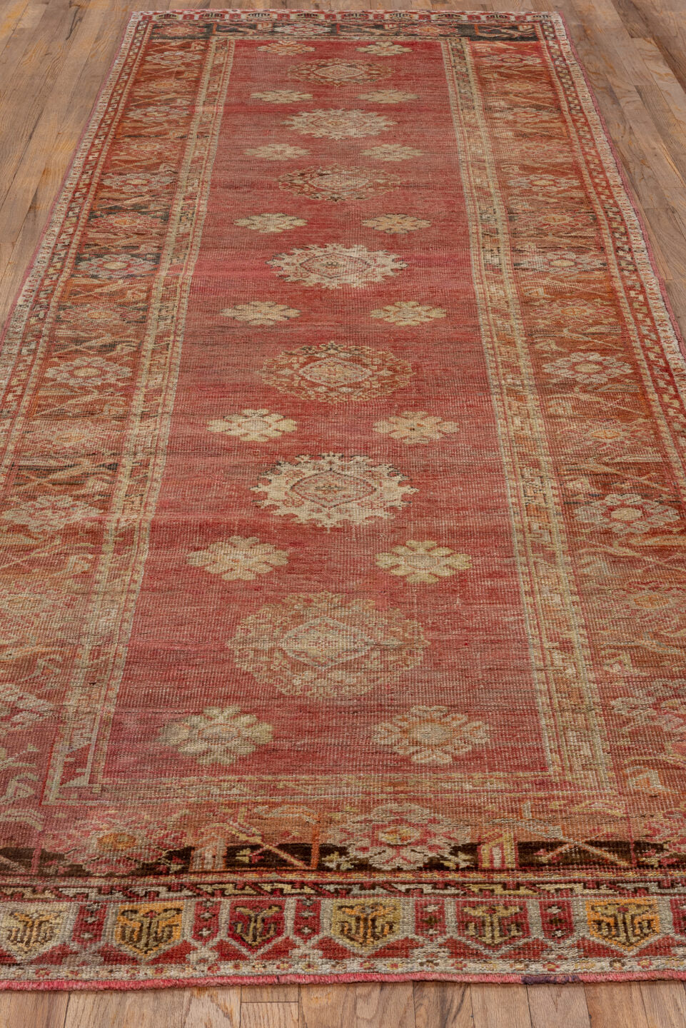 4' x 12' one-of-a-kind handmade vintage Oushak runner rug. Color palette: brown, maroon, pink, red