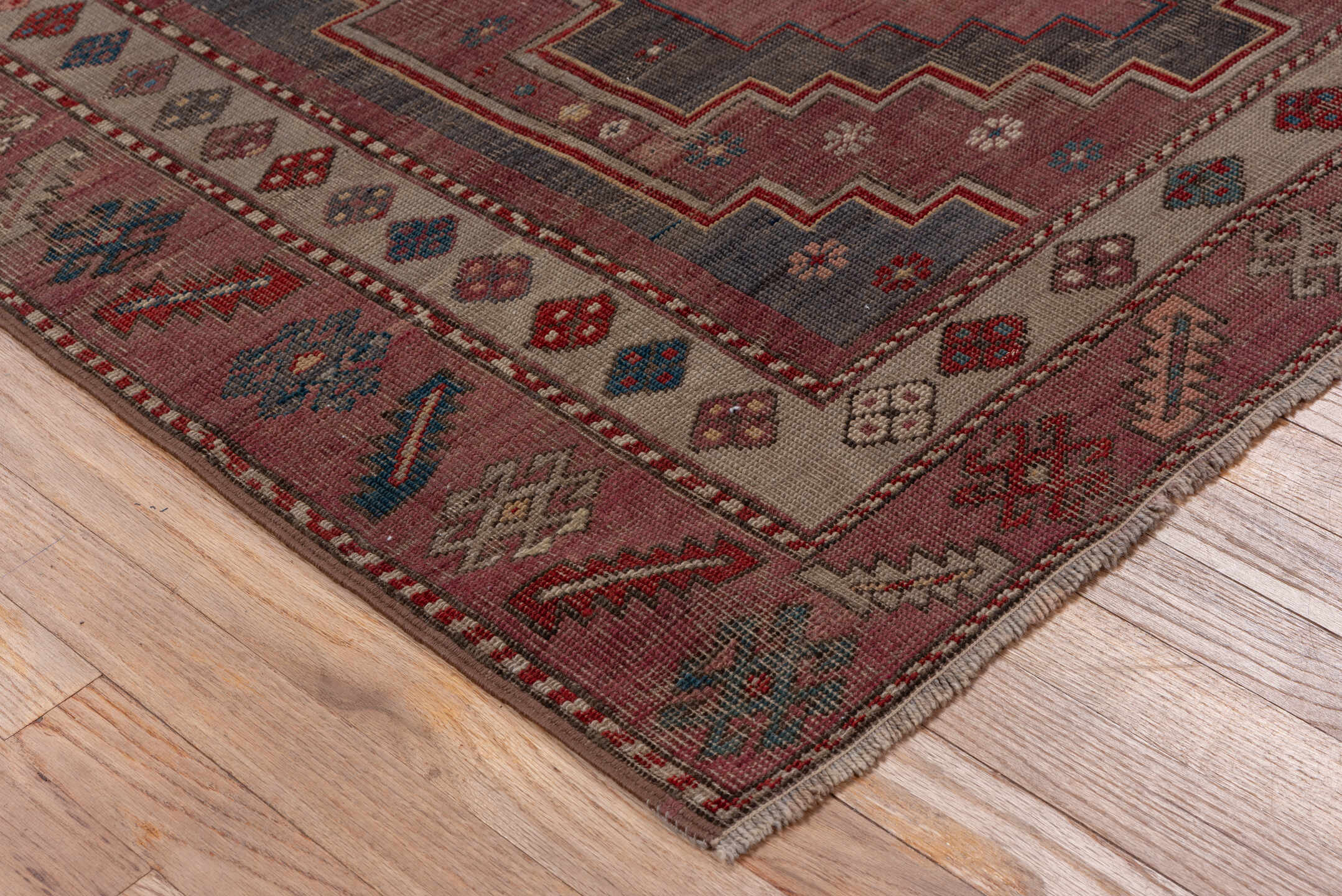 4' x 7' one-of-a-kind handmade antique Trans Caucasian rug. Color palette: rose, dusty rose, ivory, indigo, rust, taupe