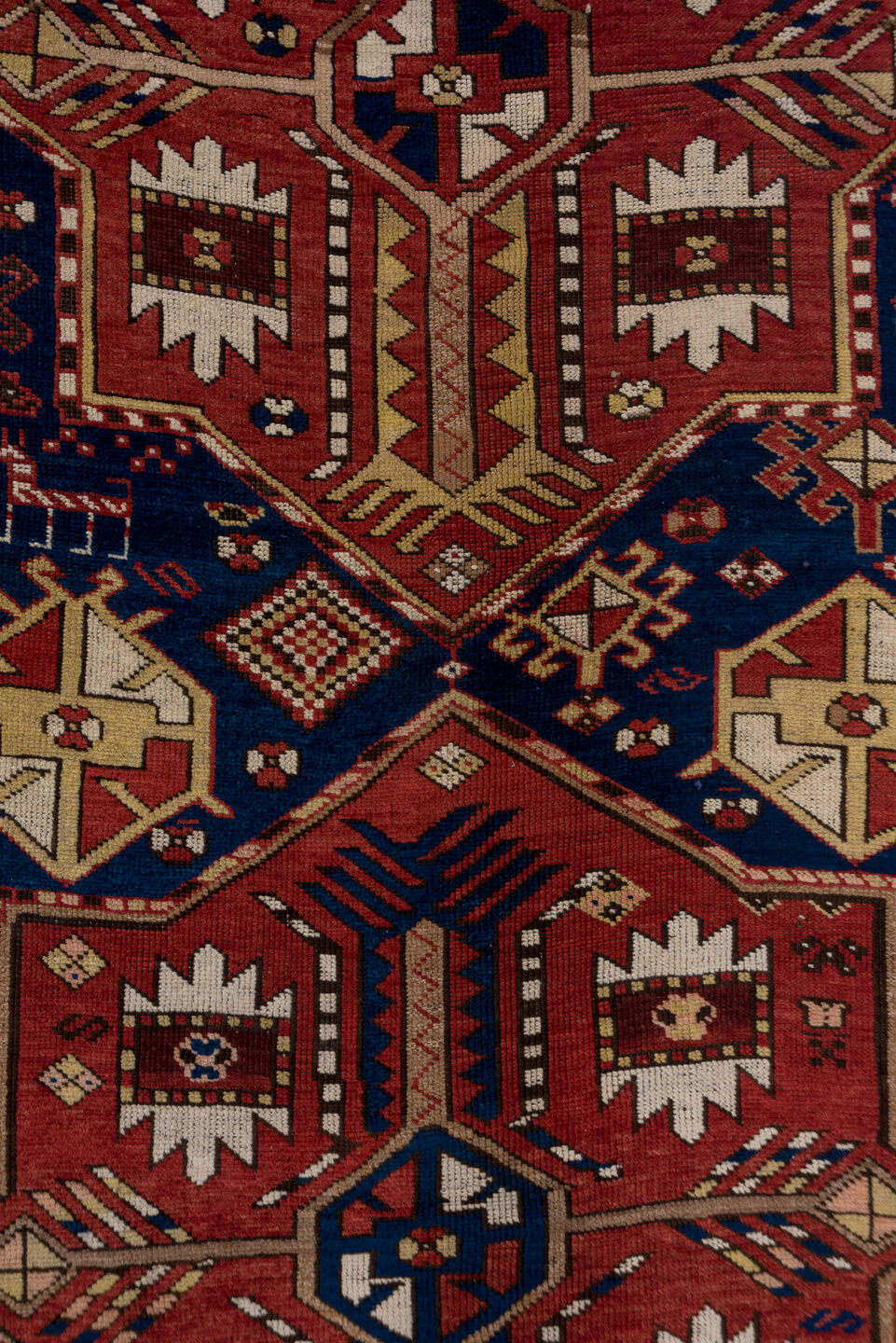 5' x 7' one-of-a-kind handmade antique Trans Caucasian rug. Color palette: rust, ivory, navy, burgundy, camel, crimson, gold