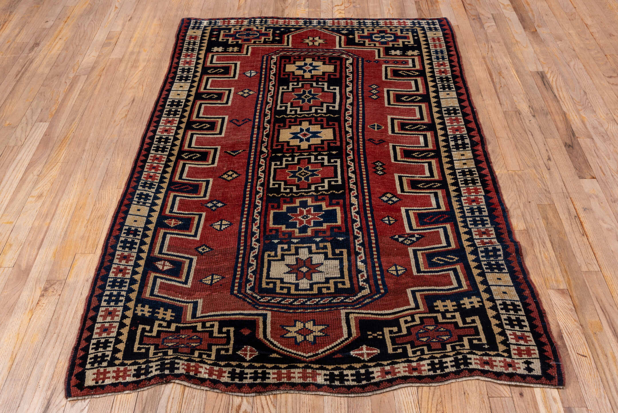 4' x 6' one-of-a-kind handmade antique Trans Caucasian small size rug. Color palette: rust, navy, ivory, crimson, indigo