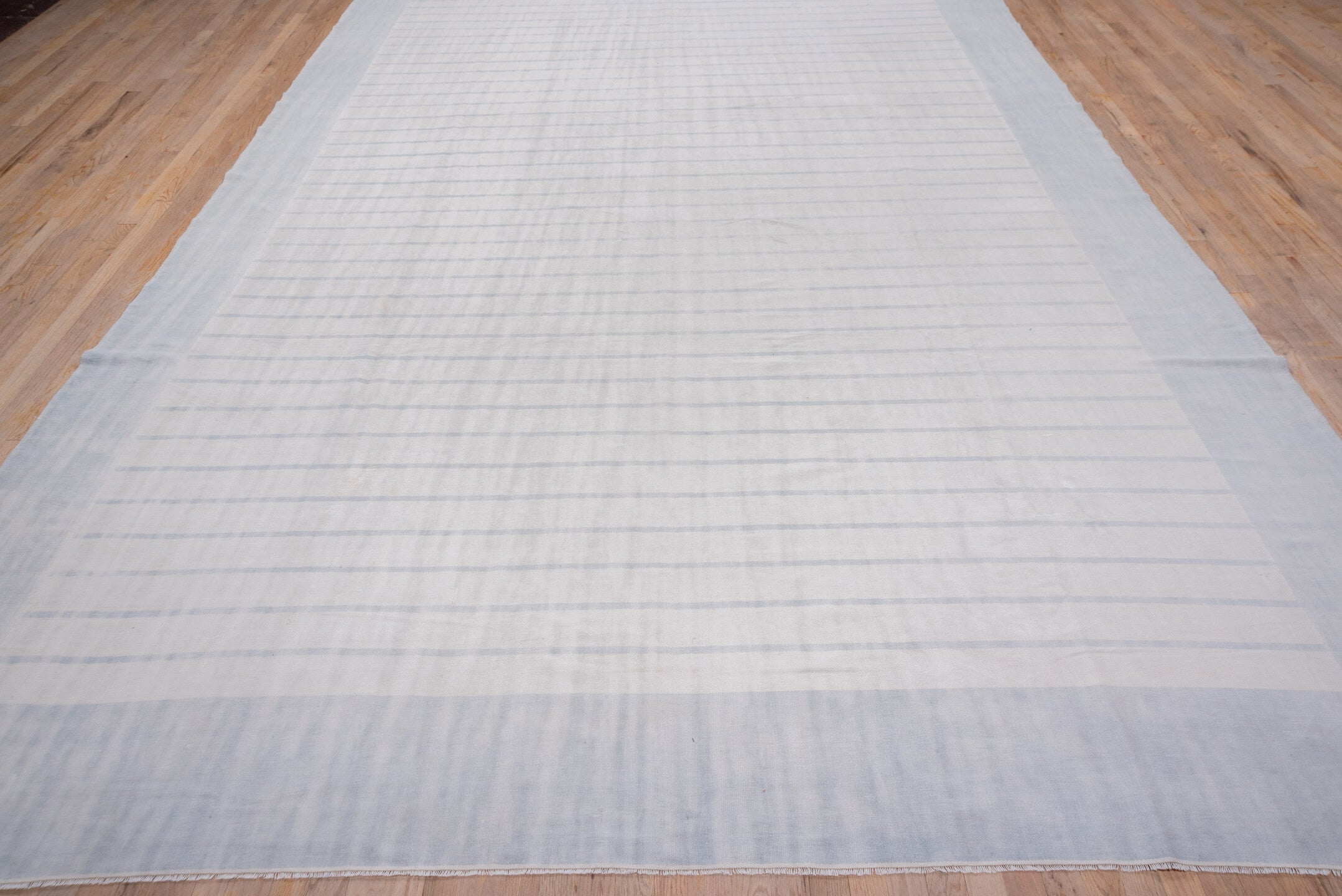 9' x 17' one-of-a-kind handmade antique Dhurrie rug. Color palette: pale blue, ivory, sky blue, light blue