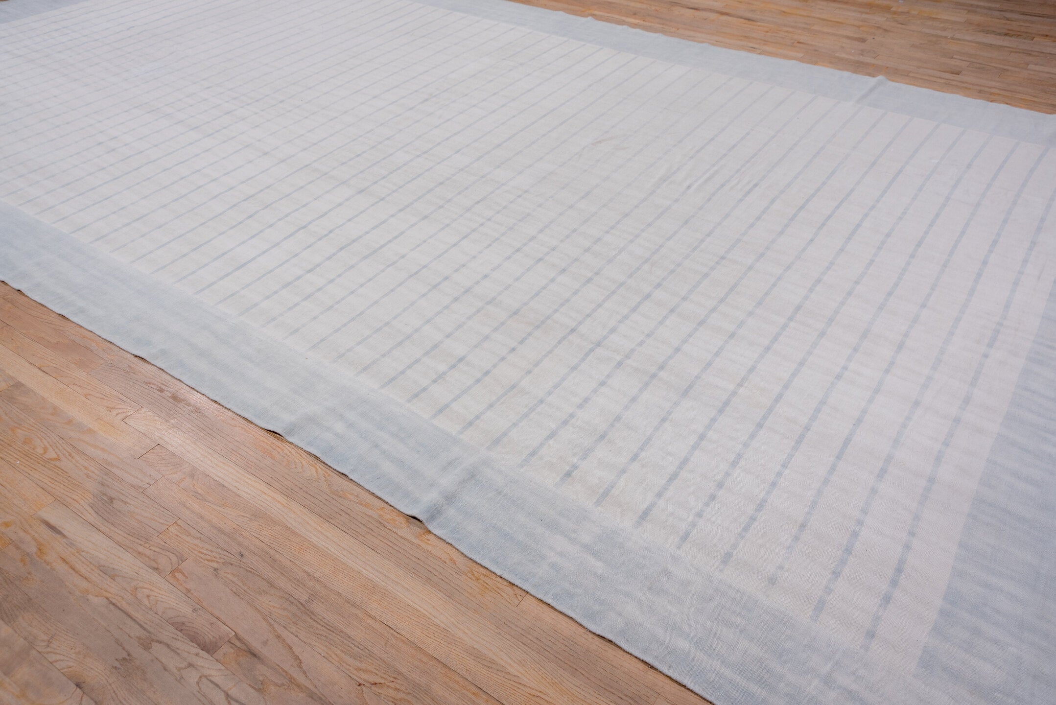9' x 17' one-of-a-kind handmade antique Dhurrie rug. Color palette: pale blue, ivory, sky blue, light blue