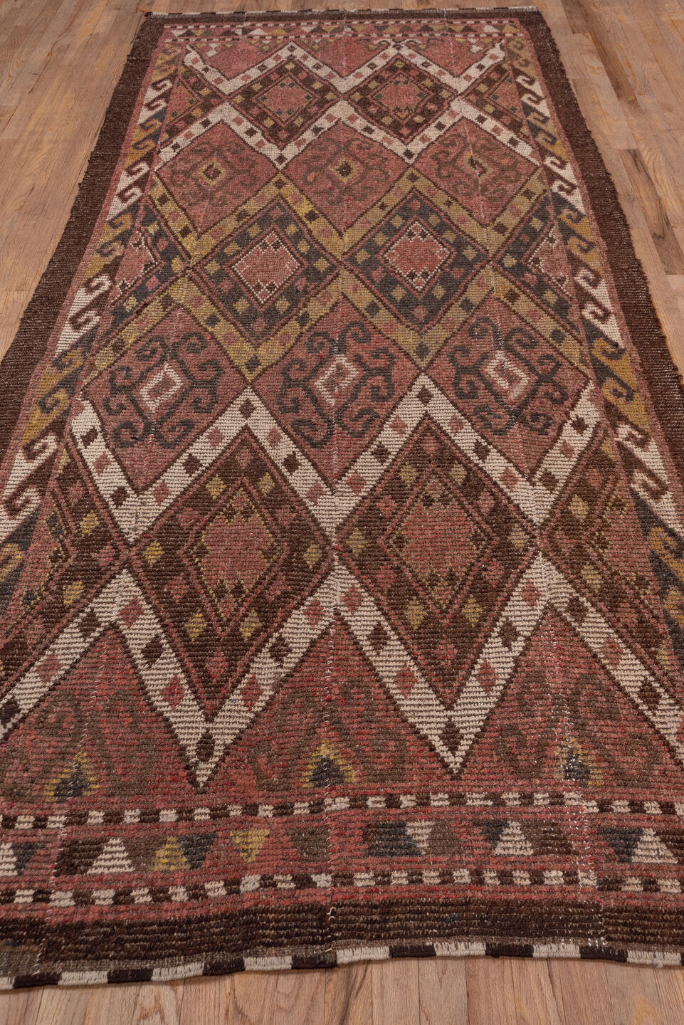 4' x 12' one-of-a-kind handmade antique Ouzbek runner rug. Color palette: rose, brown, ivory, ochre, mahogany, taupe, pink