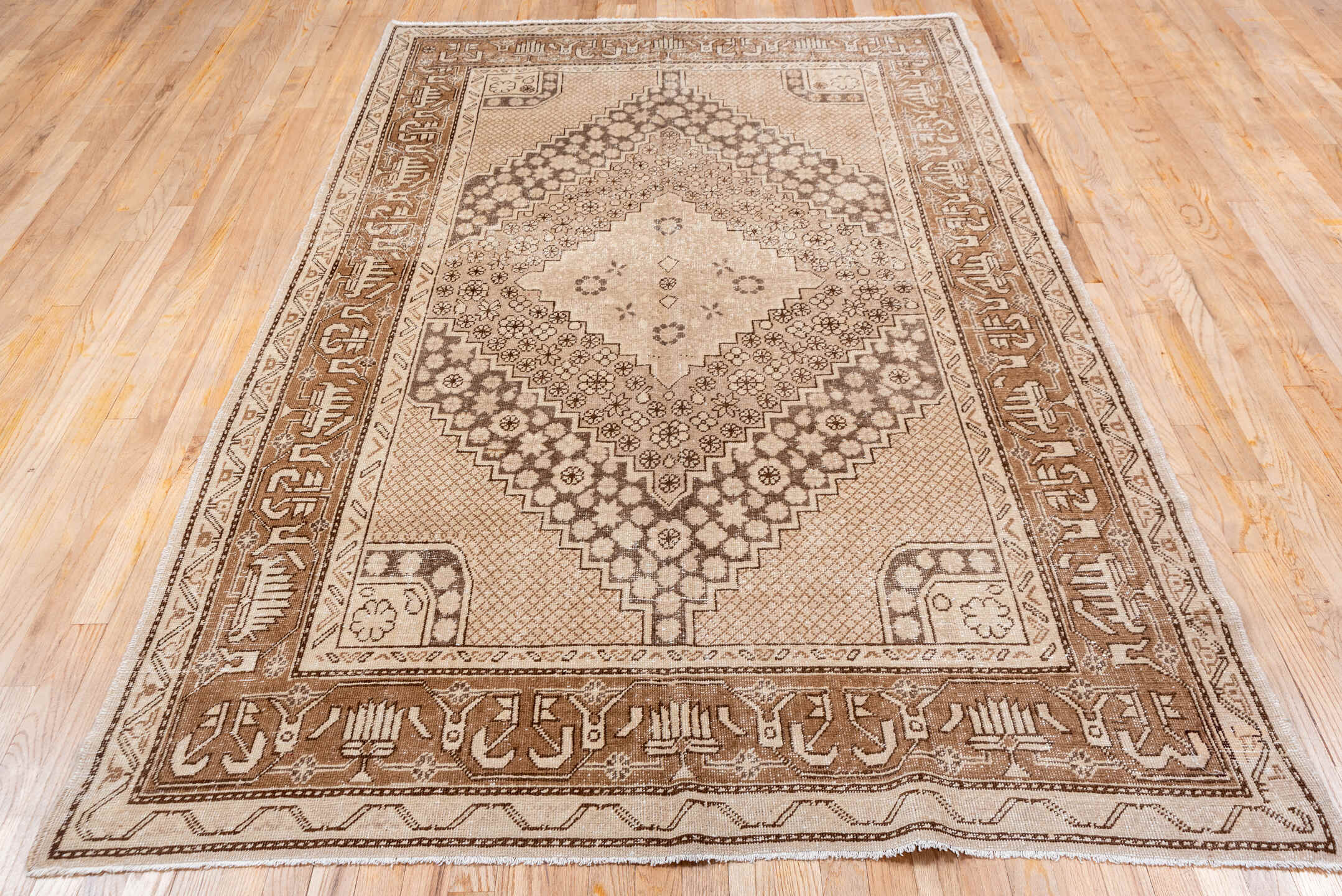 5' x 8' one-of-a-kind handmade vintage Khotan medium size rug. Color palette: brown, gray, light gray, off-white, orange