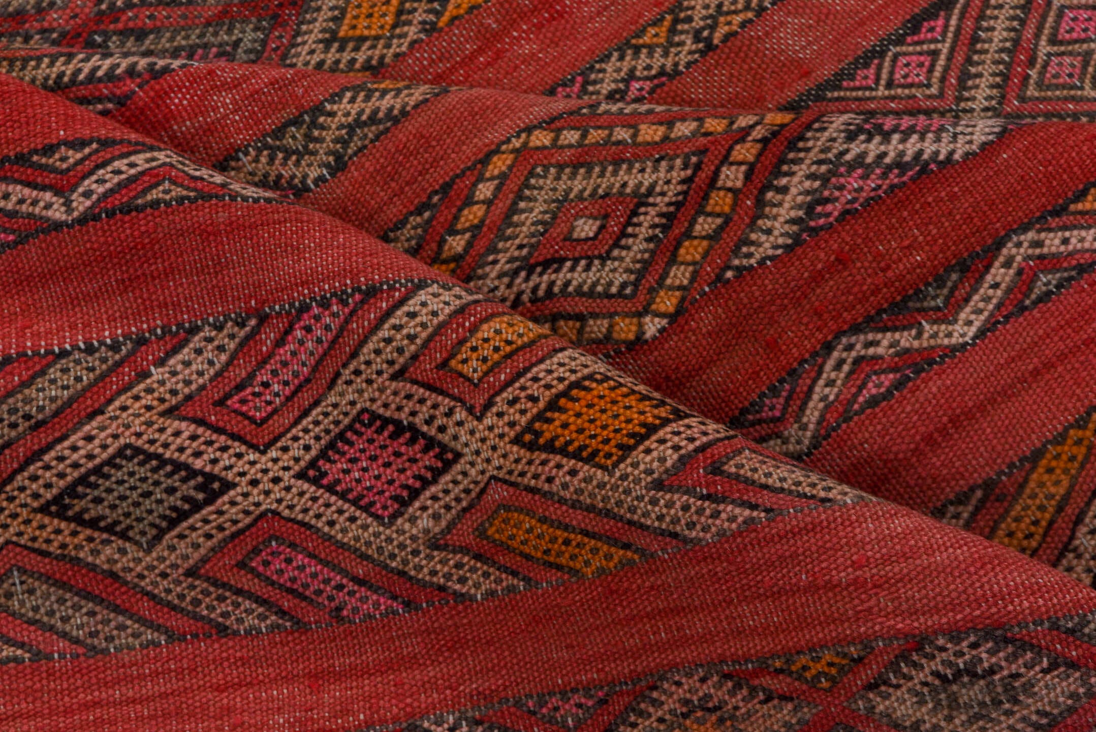 5' x 7' one-of-a-kind handmade vintage Kilim rug. Color palette: rose, rust, charcoal, taupe, ochre, pink, ivory, red