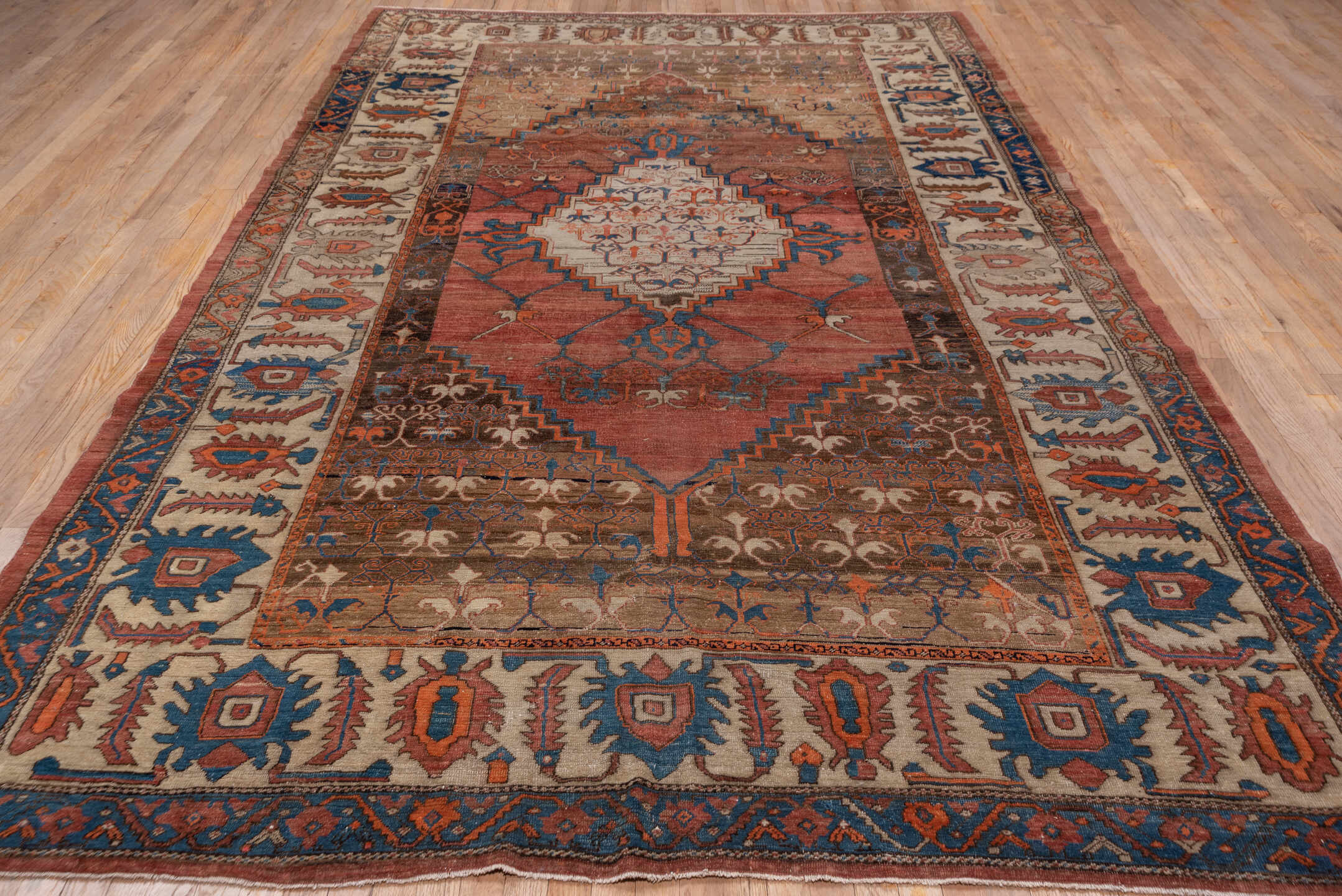7' x 12' one-of-a-kind handmade antique Bakhshayesh large size rug. Color palette: terra cotta, ivory, cobalt, rust, taupe