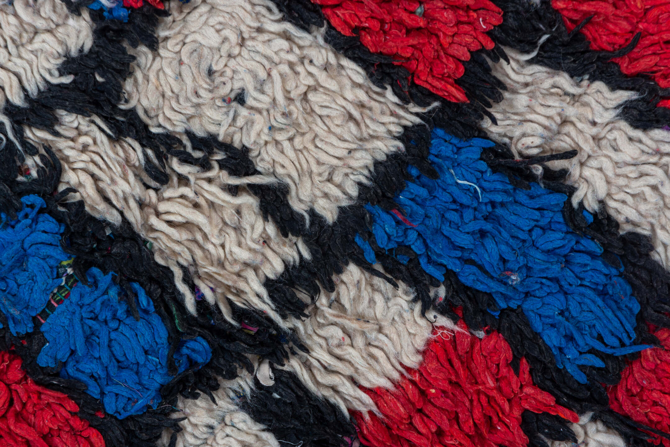 4' x 10' one-of-a-kind handmade vintage Moroccan runner rug. Color palette: ivory, cobalt, crimson, black, blue, red