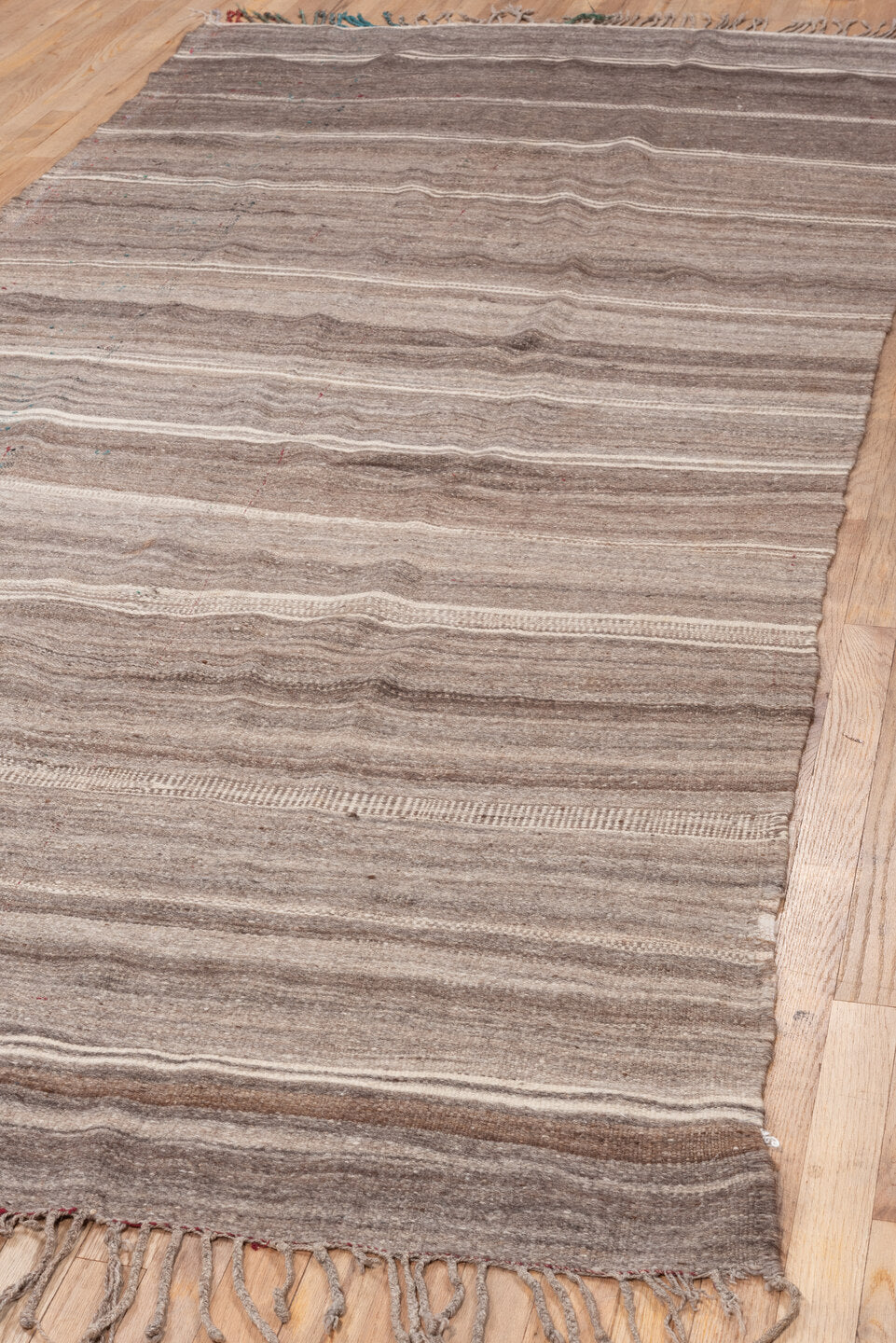 4' x 10' one-of-a-kind handmade vintage Blanket runner rug. Color palette: taupe, brown, ivory, charcoal, beige, gray, black