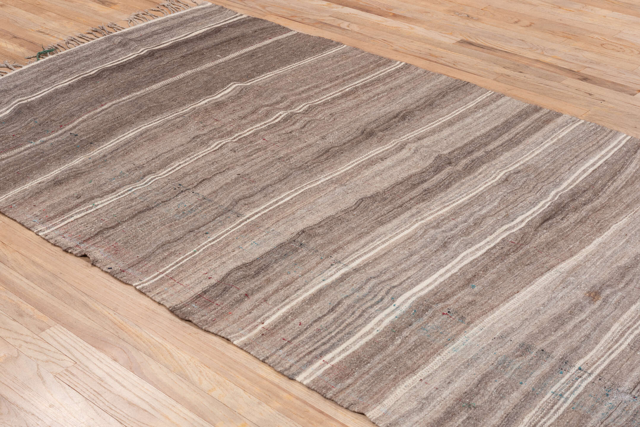 4' x 10' one-of-a-kind handmade vintage Blanket runner rug. Color palette: brown, gray, light gray, off-white, pink