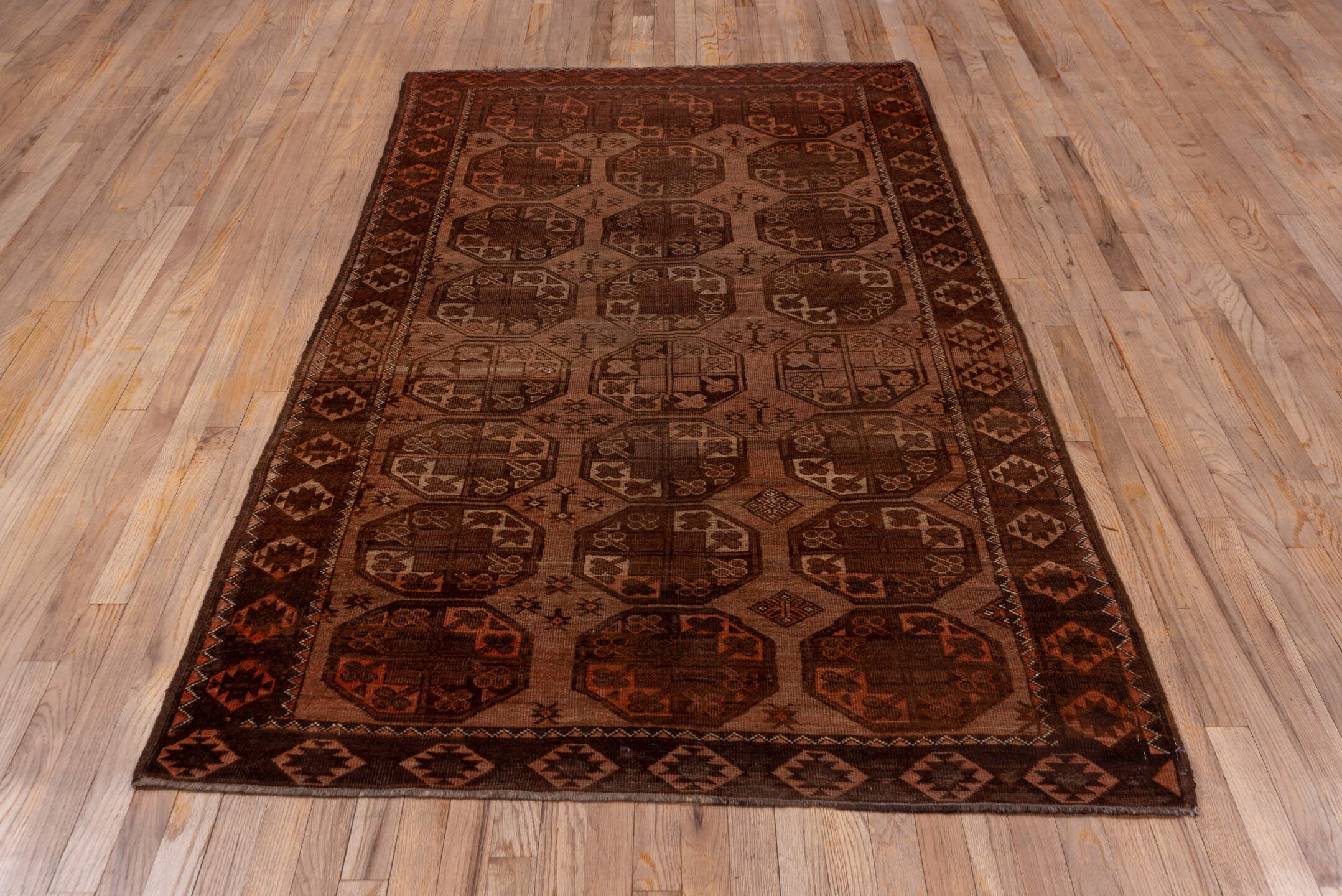 4' x 7' one-of-a-kind handmade antique Afghan rug. Color palette: brown, rust, camel, mahogany, taupe, terra cotta, charcoal