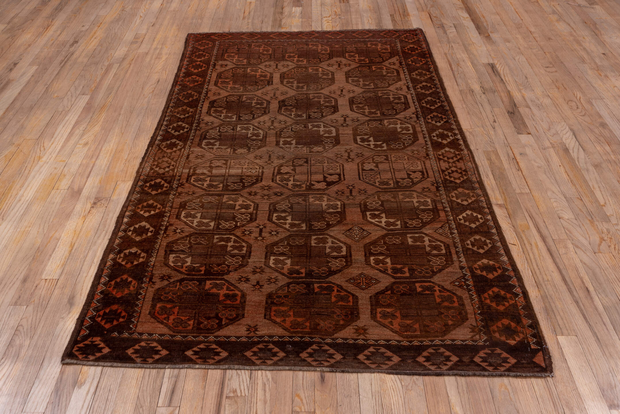 4' x 7' one-of-a-kind handmade antique Afghan rug. Color palette: brown, rust, camel, mahogany, taupe, terra cotta, charcoal