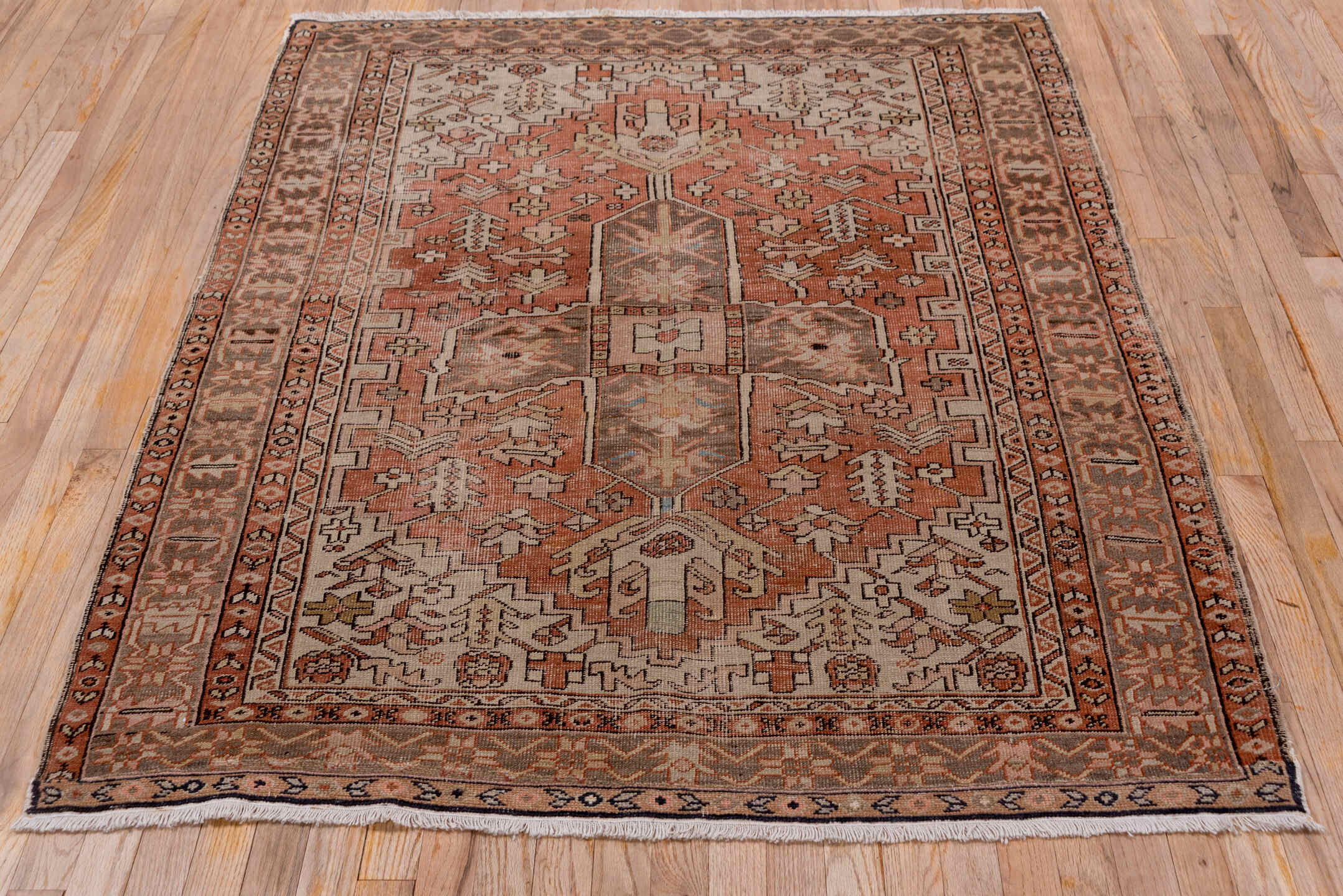 4' x 5' one-of-a-kind handmade antique Serapi small size rug. Color palette: terra cotta, taupe, brown, ivory, camel, slate