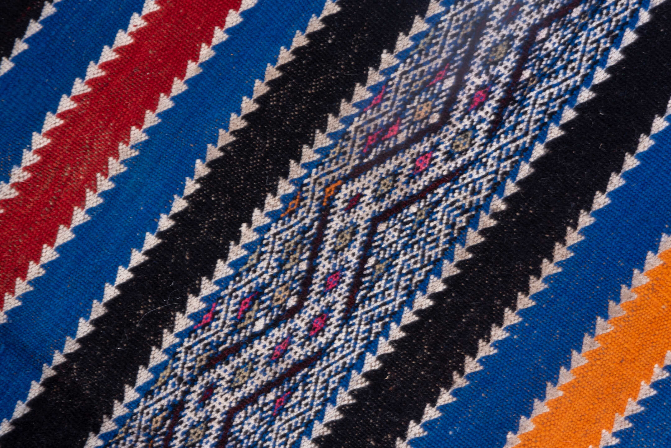 5' x 11' one-of-a-kind handmade vintage Kilim rug. Color palette: indigo, ivory, charcoal, rust, burgundy, blue, purple