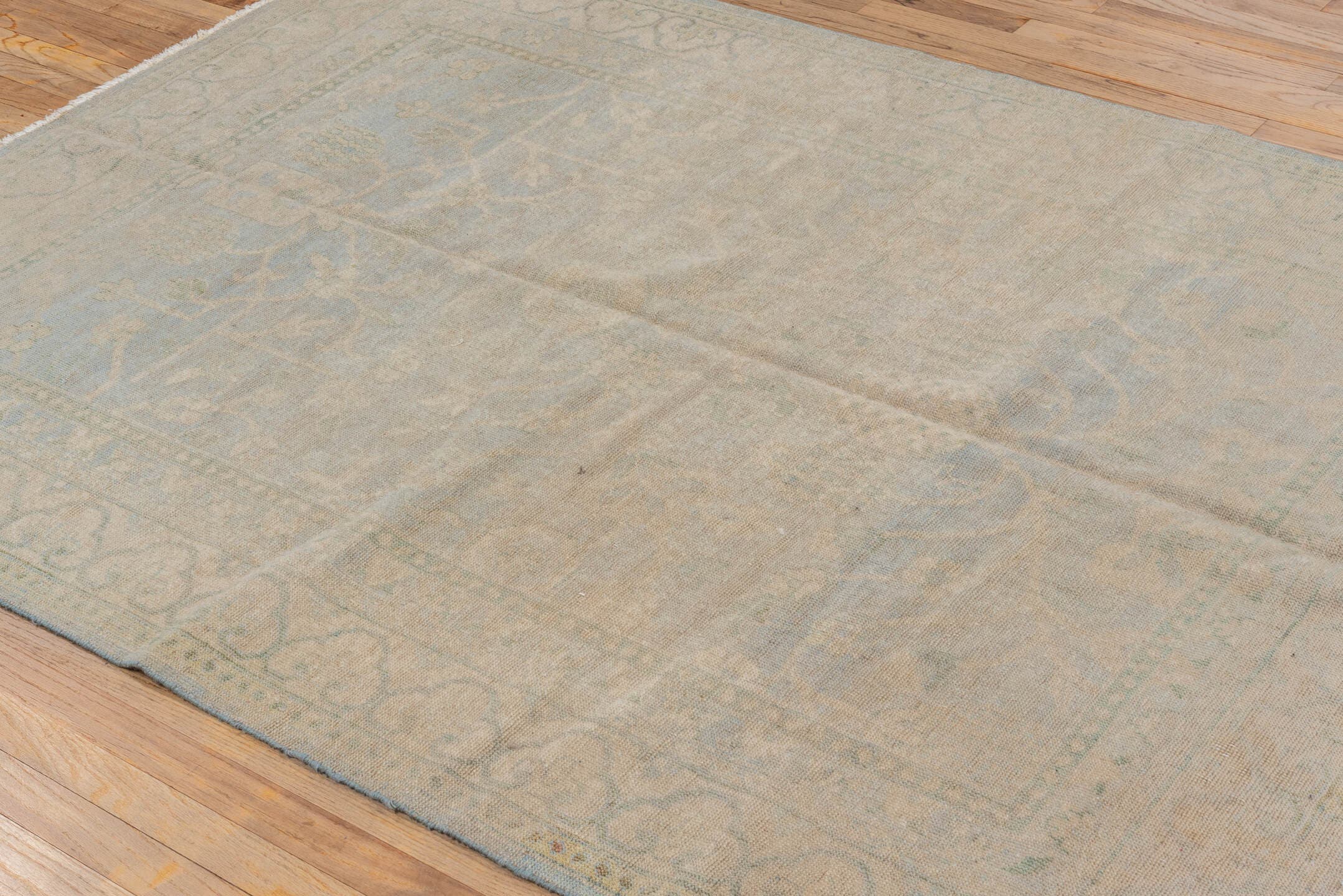 5' x 7' one-of-a-kind handmade vintage Khotan rug. Color palette: beige, ivory, pale blue, taupe, sage, light blue, gray