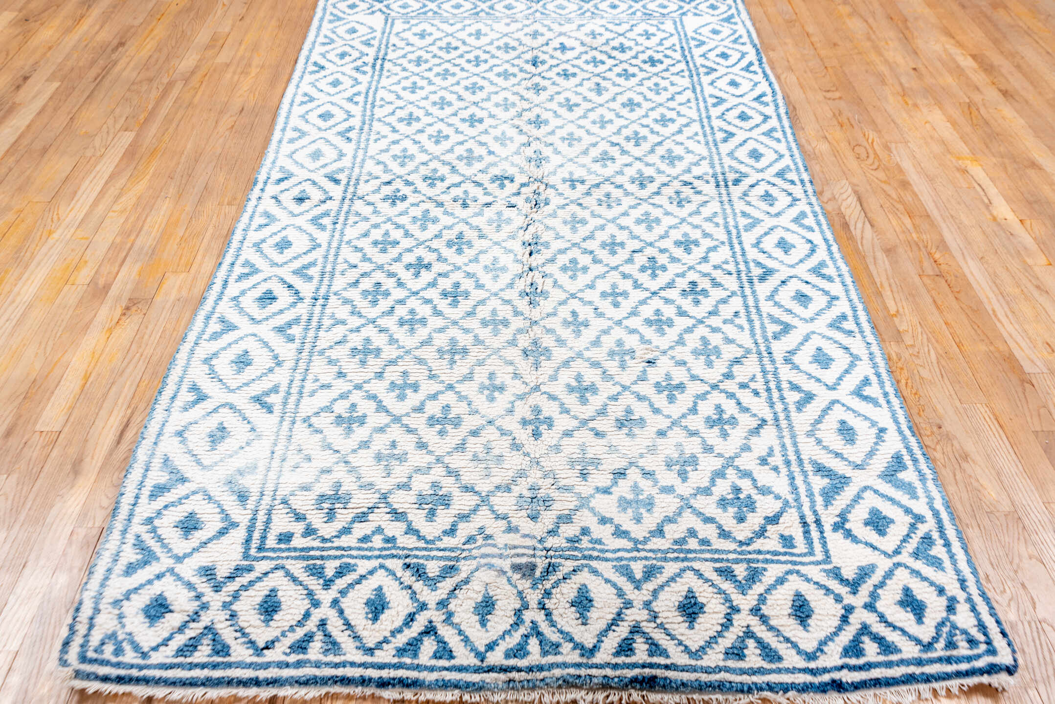 5' x 9' one-of-a-kind handmade vintage Cotton Agra medium size rug. Color palette: ivory, sky blue, powder blue, light blue