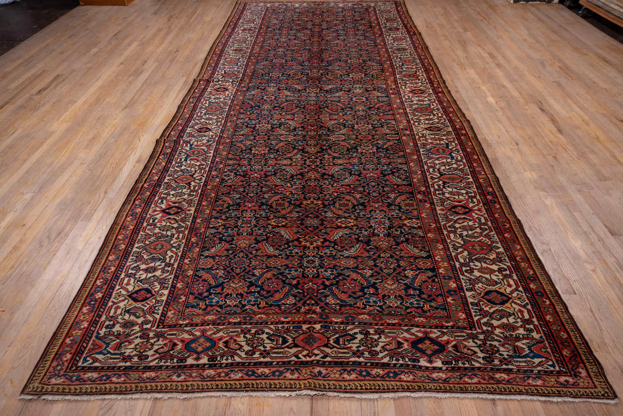 7' x 17' one-of-a-kind handmade antique Mahal rug. Color palette: navy, rust, ivory, coral, indigo, camel, burgundy, blue