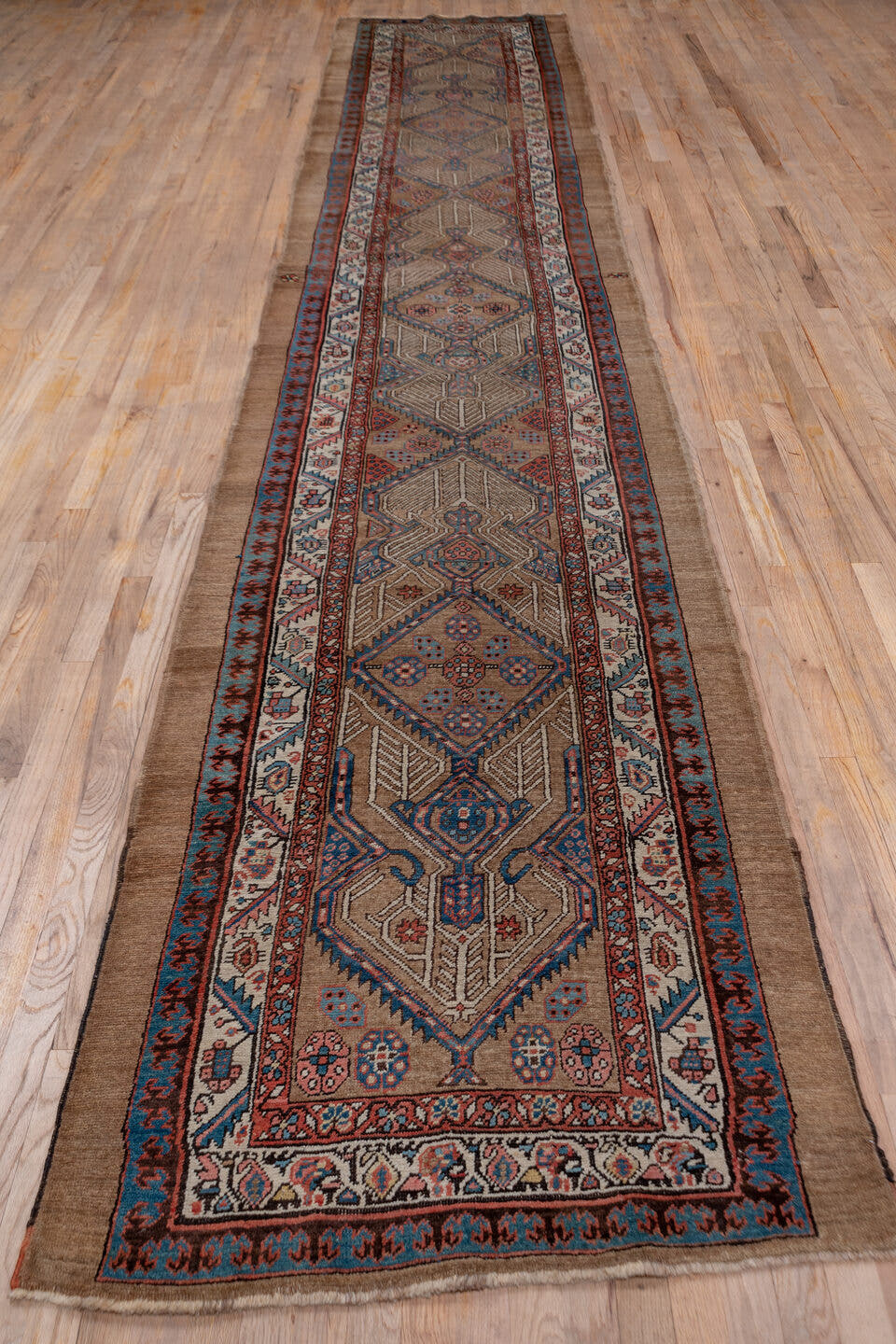3' x 18' one-of-a-kind handmade vintage Serapi runner rug. Color palette: taupe, rust, ivory, blue, brown, slate, beige