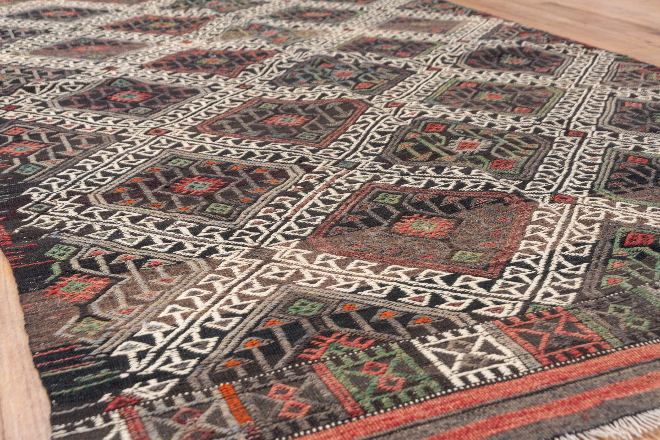 4' x 8' one-of-a-kind handmade vintage Jijim rug. Color palette: charcoal, ivory, rust, olive, taupe, rose, slate, gray