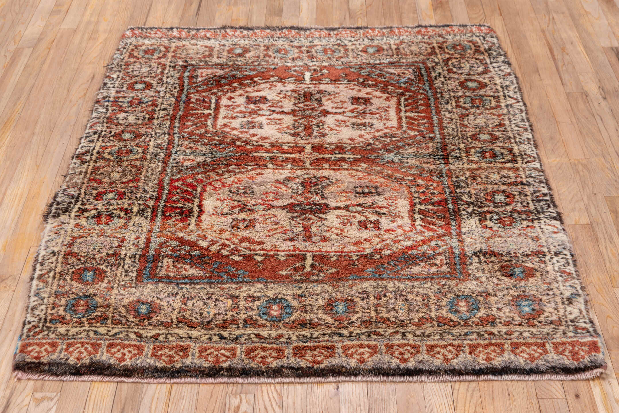 4' x 5' one-of-a-kind handmade vintage Tulu small size rug. Color palette: ivory, rust, charcoal, soft blue, terracotta