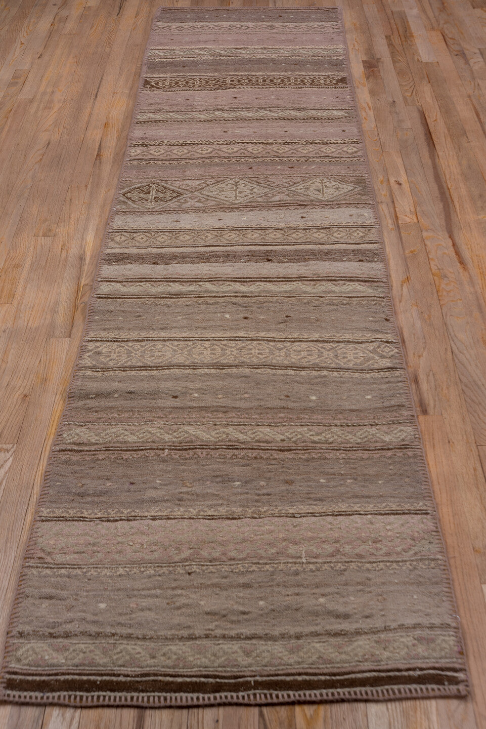 2' x 10' one-of-a-kind handmade vintage Kilim runner rug. Color palette: brown, gray, off-white, pink, snow, white