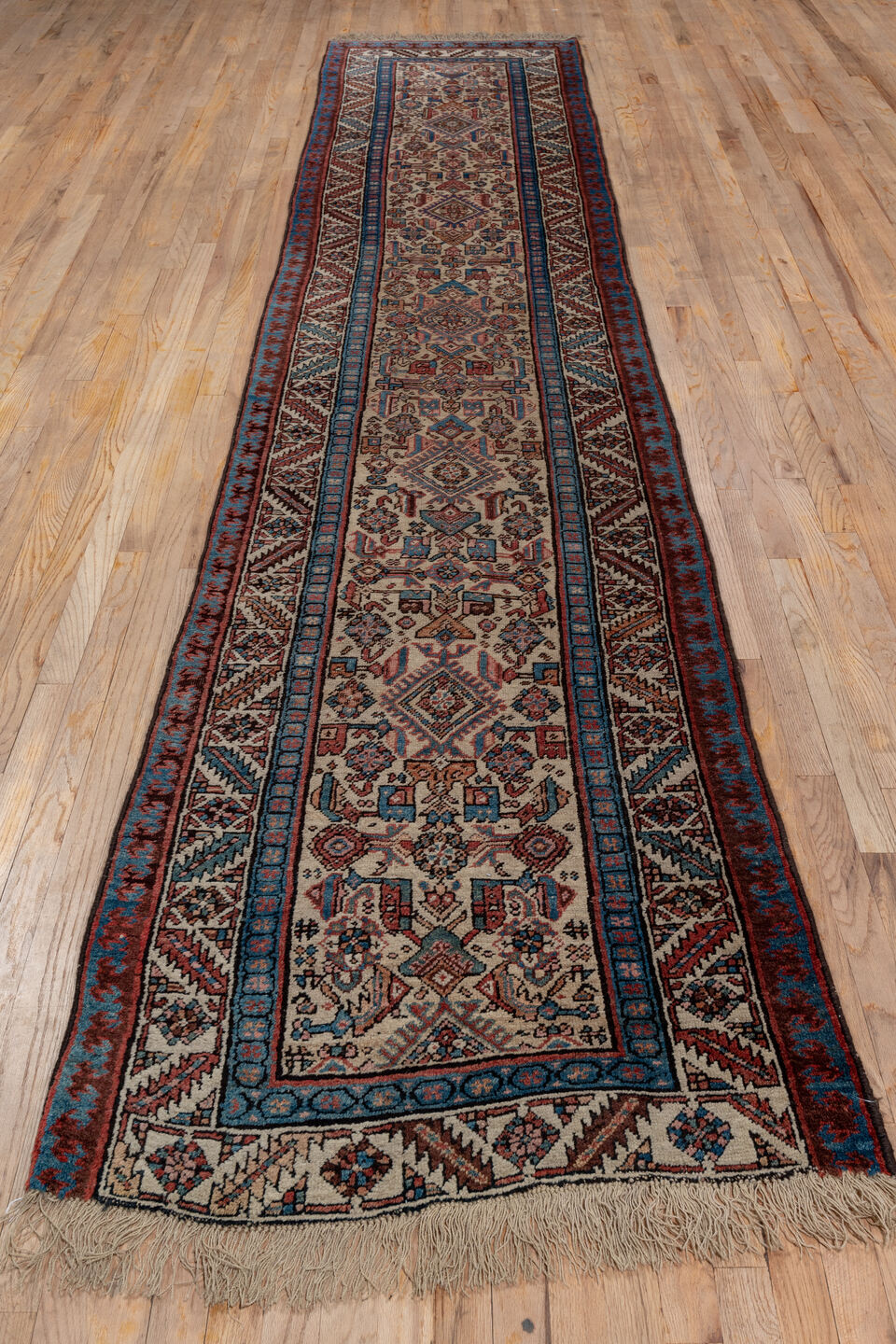 3' x 13' one-of-a-kind handmade antique Sarab runner rug. Color palette: ivory, rust, indigo, burgundy, camel, slate