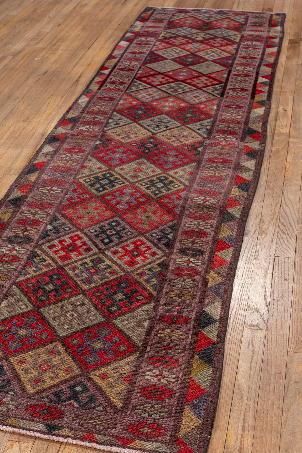 2' x 10' one-of-a-kind handmade vintage Oushak runner rug. Color palette: brown, burgundy, gray, pink, red, redwood