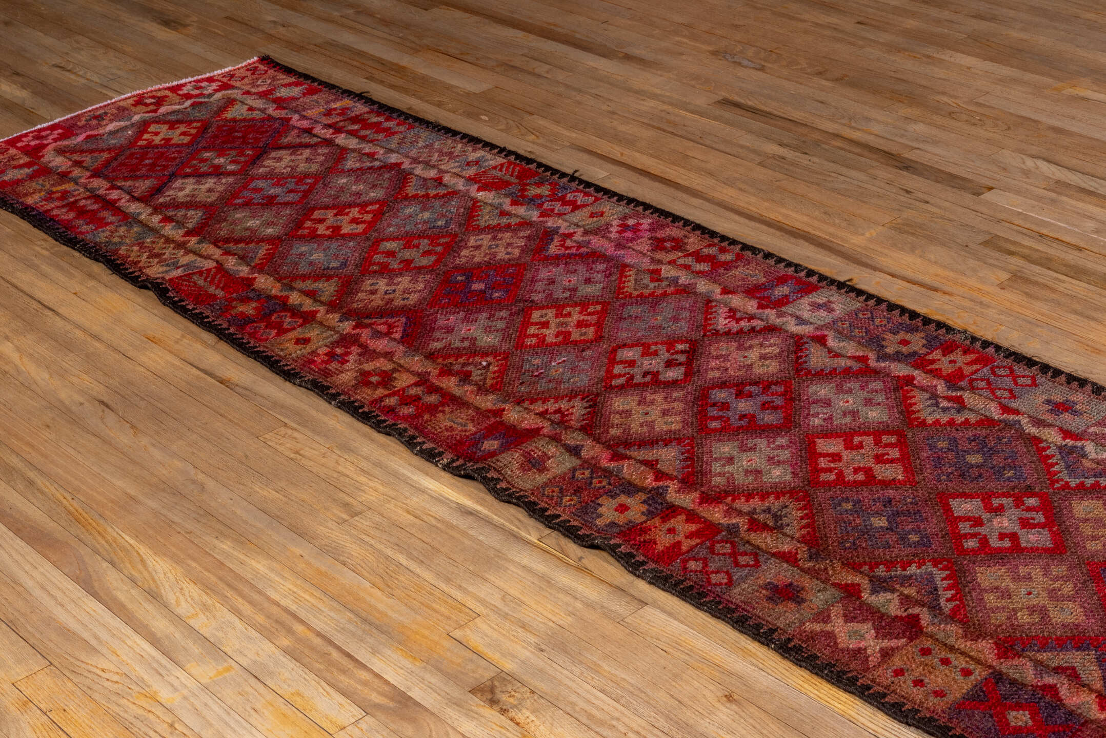 2' x 11' one-of-a-kind handmade vintage Oushak runner rug. Color palette: black, brown, burgundy, gray, pink, red