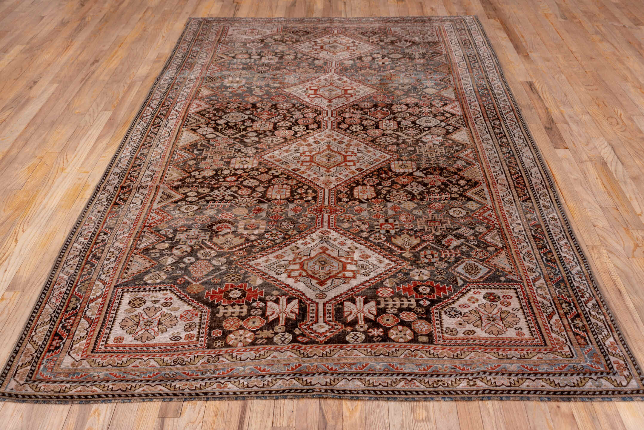 5' x 10' one-of-a-kind handmade vintage Qashqai medium size rug. Color palette: black, brown, gray, pink, redwood
