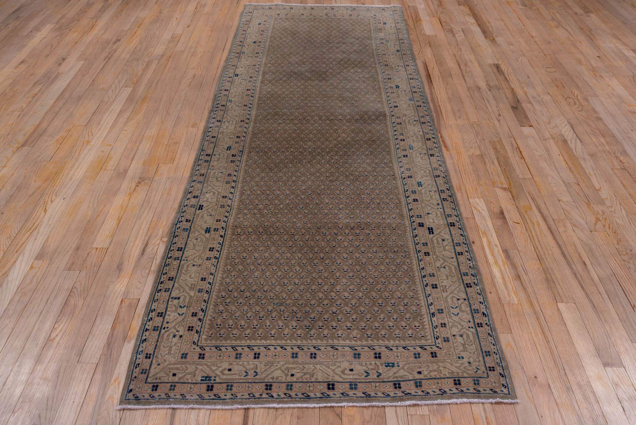 3' x 10' one-of-a-kind handmade vintage Mahal runner rug. Color palette: taupe, brown, beige, indigo, ivory, camel, gray