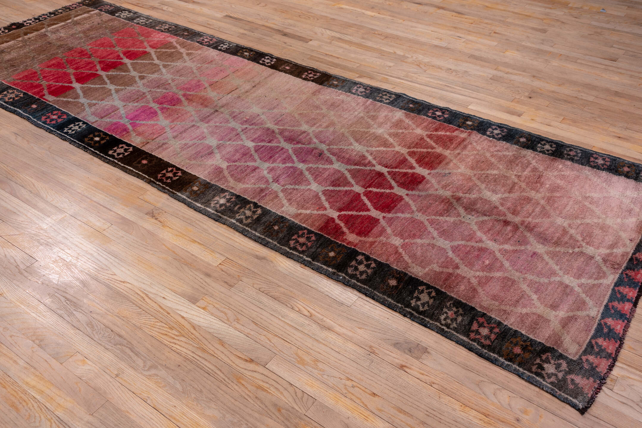 4' x 12' one-of-a-kind handmade vintage Kars runner rug. Color palette: black, blue, brown, gray, pink, red, redwood