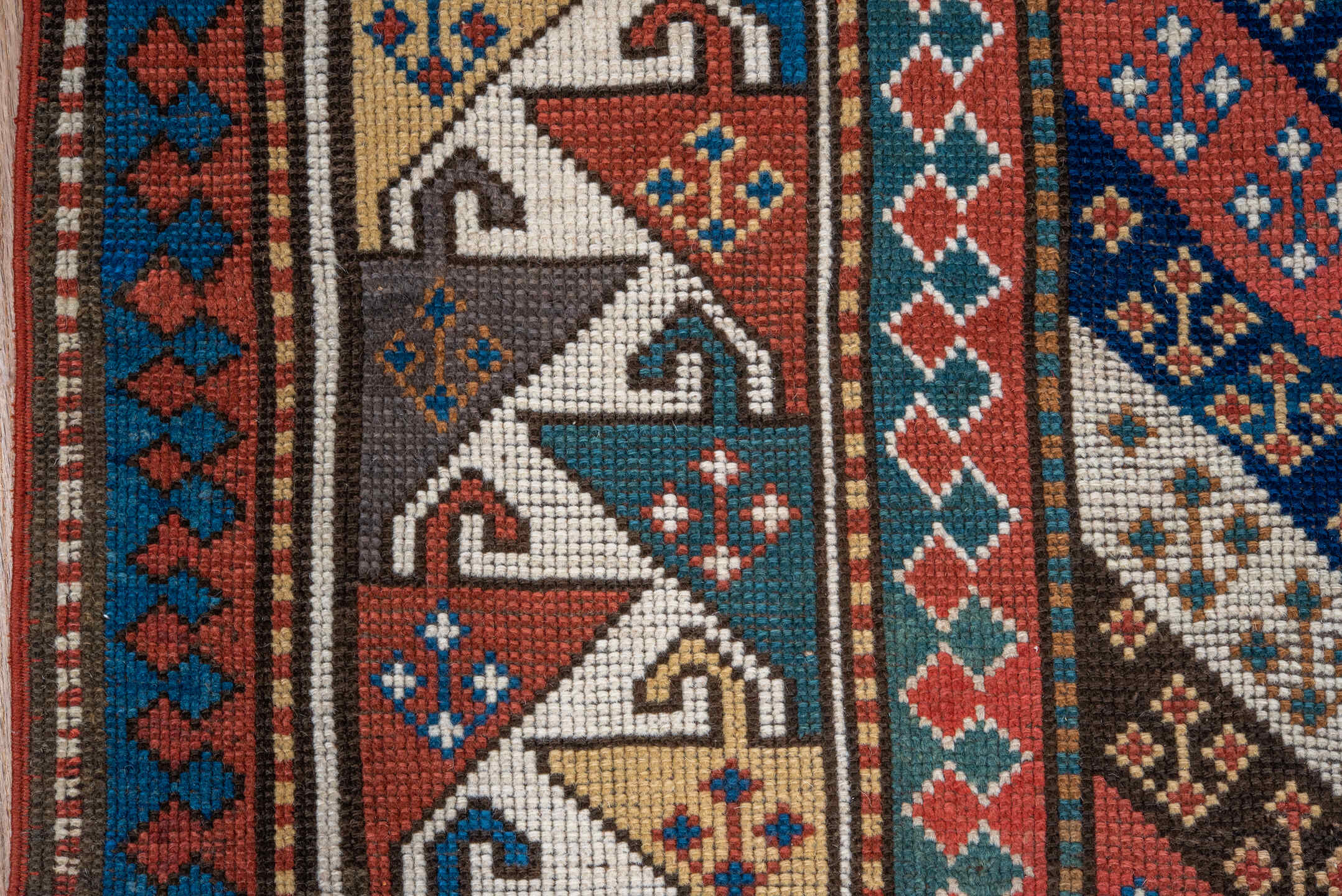 3' x 6' one-of-a-kind handmade antique Kazak small size rug. Color palette: ivory, navy, turquoise, rust, camel, terracotta