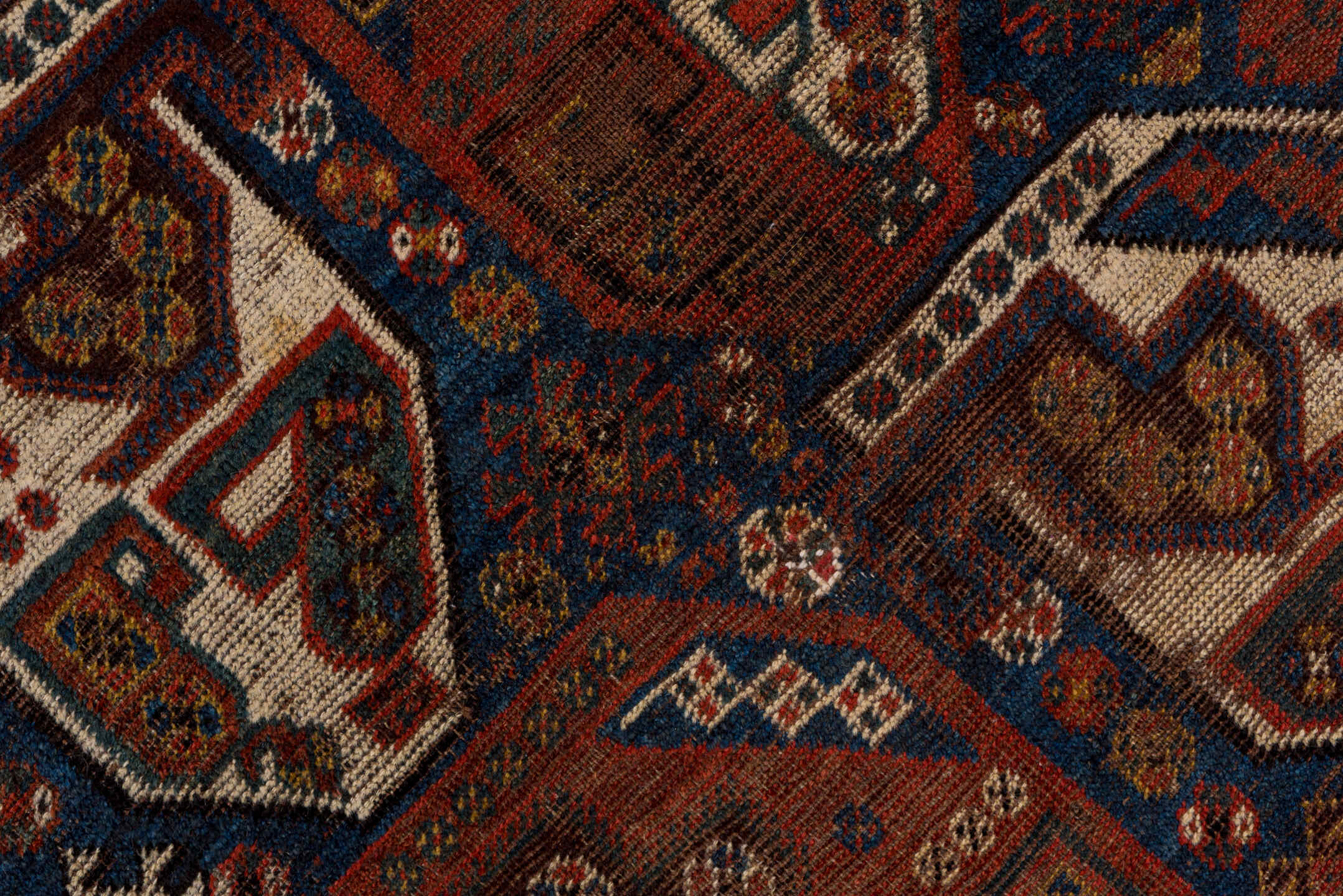 7' x 9' one-of-a-kind handmade antique Shiraz rug. Color palette: rust, indigo, ivory, brick, camel, navy, brown, terracotta