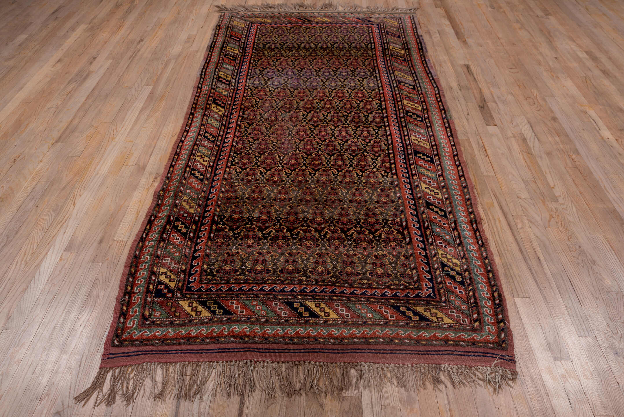 4' x 9' one-of-a-kind handmade vintage Kurd rug. Color palette: brown, dark gray, gray, light gray, off-white, pink, red