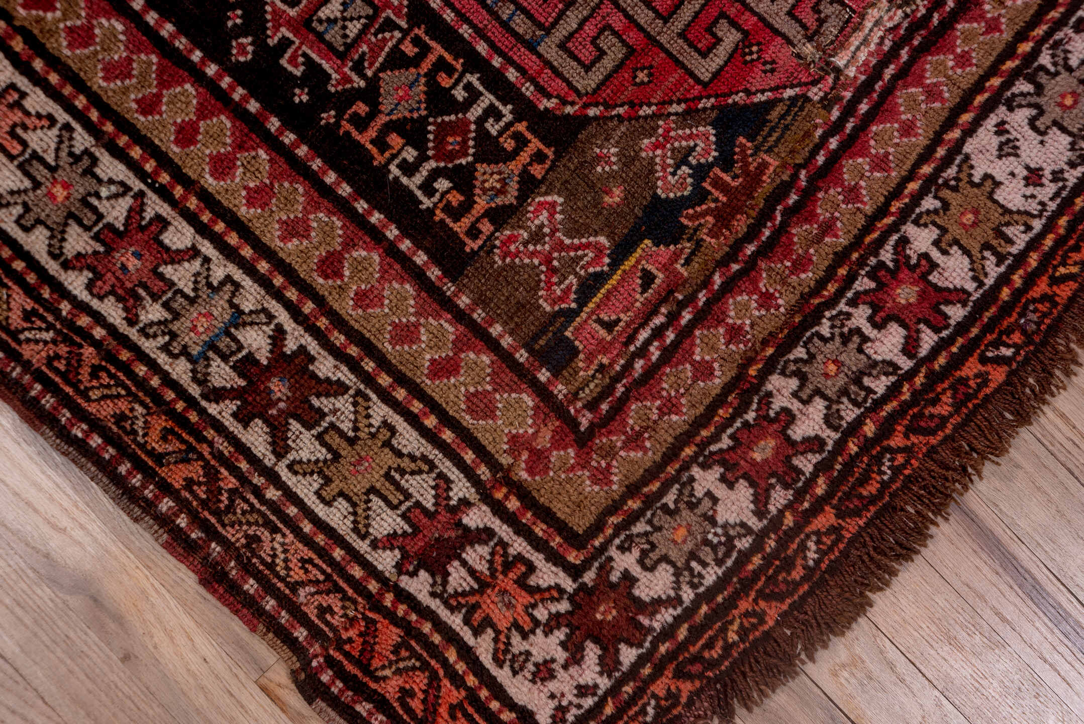 4' x 9' one-of-a-kind handmade vintage Kazak runner rug. Color palette: brown, gray, pink, red, rosy brown