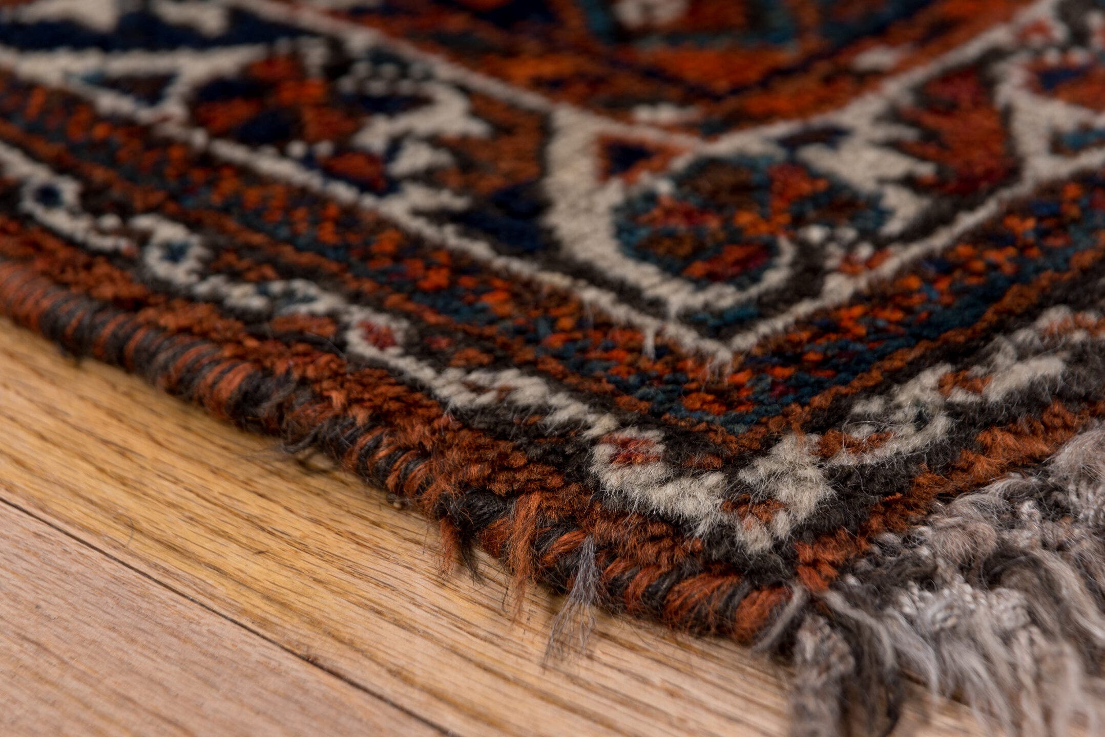 2' x 4' one-of-a-kind handmade antique Shiraz small size rug. Color palette: rust, indigo, ivory, terra cotta, teal